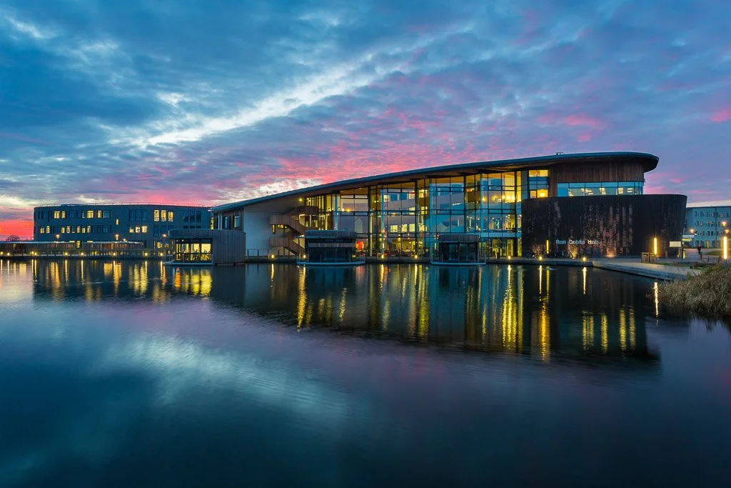 york university ron cooke hub at dusk from across the water