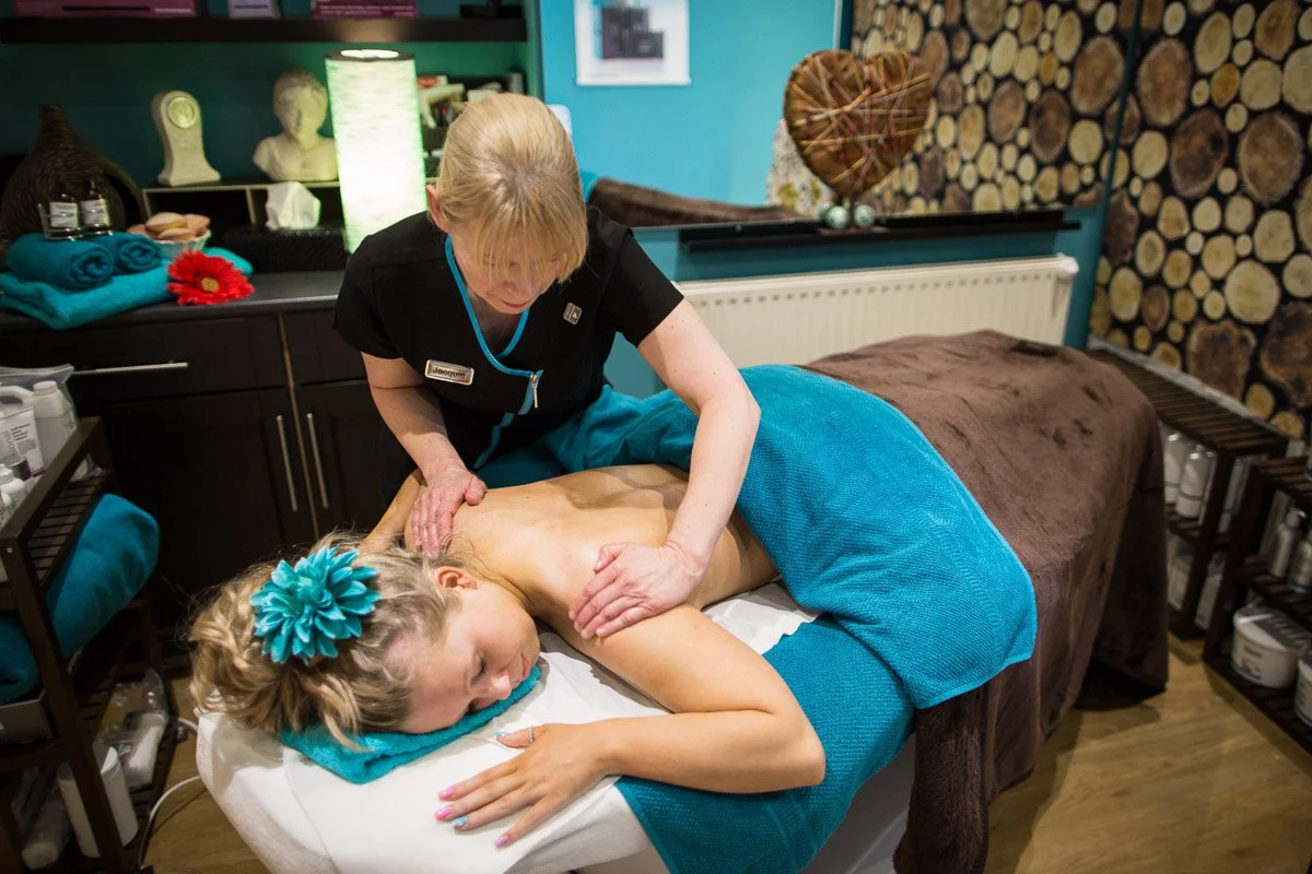 lady performing a massage to a client 