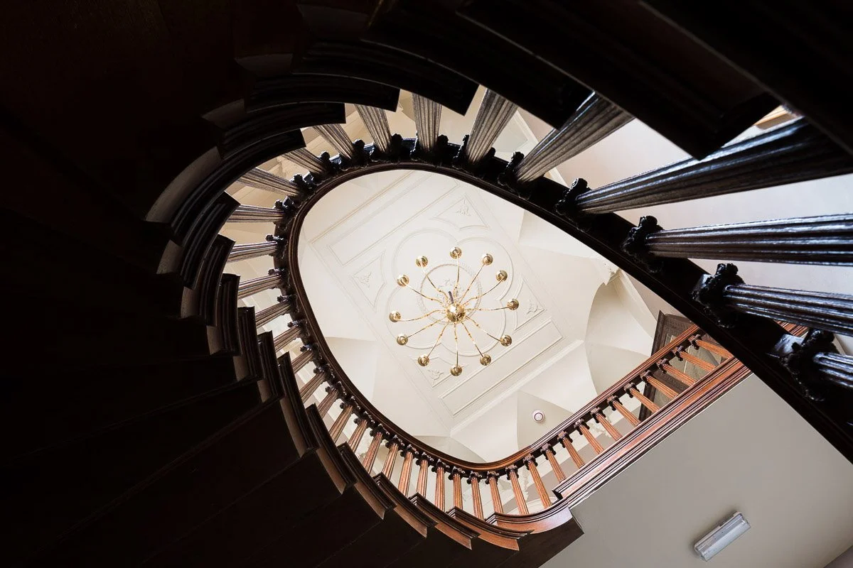 looking up through a spiral stair case towards the ceiling 