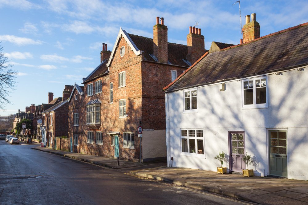  street scene of old cottages in the sun  
