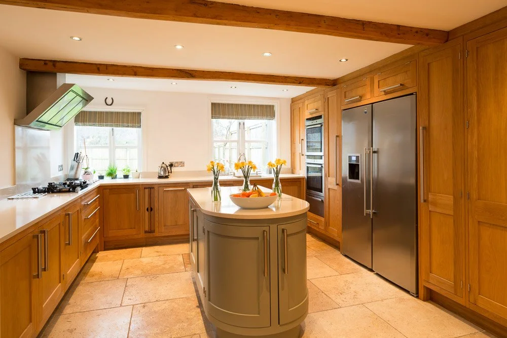  badly lit kitchen with tile flooring, wooden units white worktops, orange coloured image 