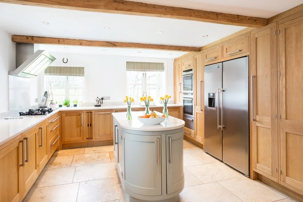  well lit kitchen with tile flooring, wooden units white worktops 