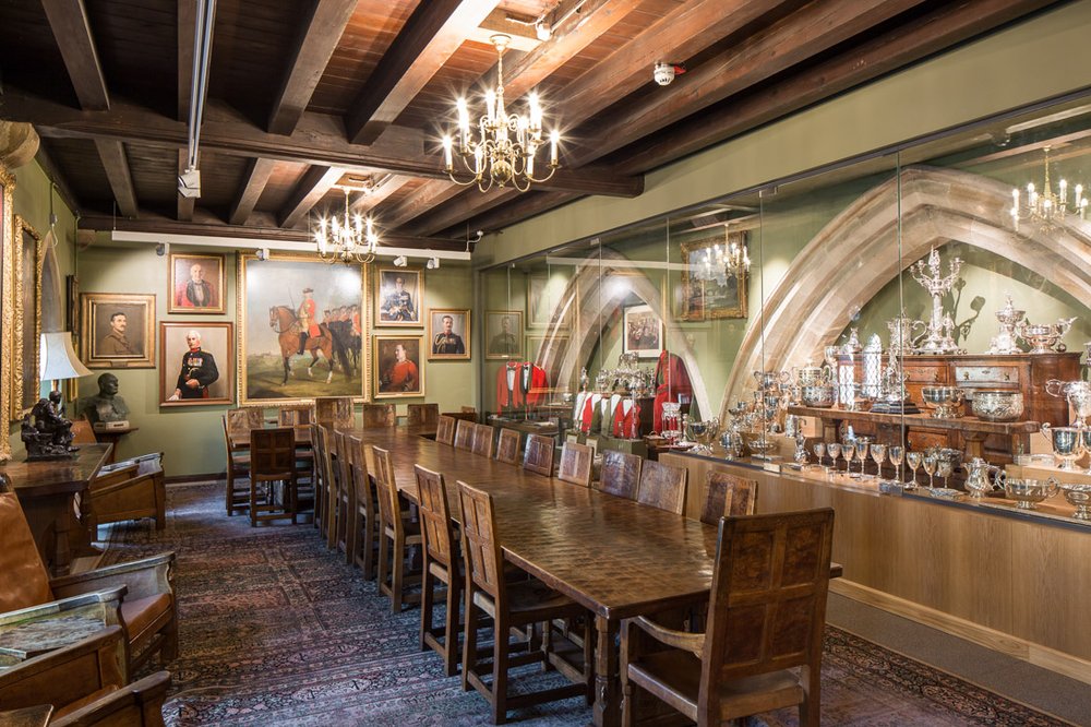  large dining hall in the green Howards museum with beamed wooden ceiling, large wooden table and dining chairs  