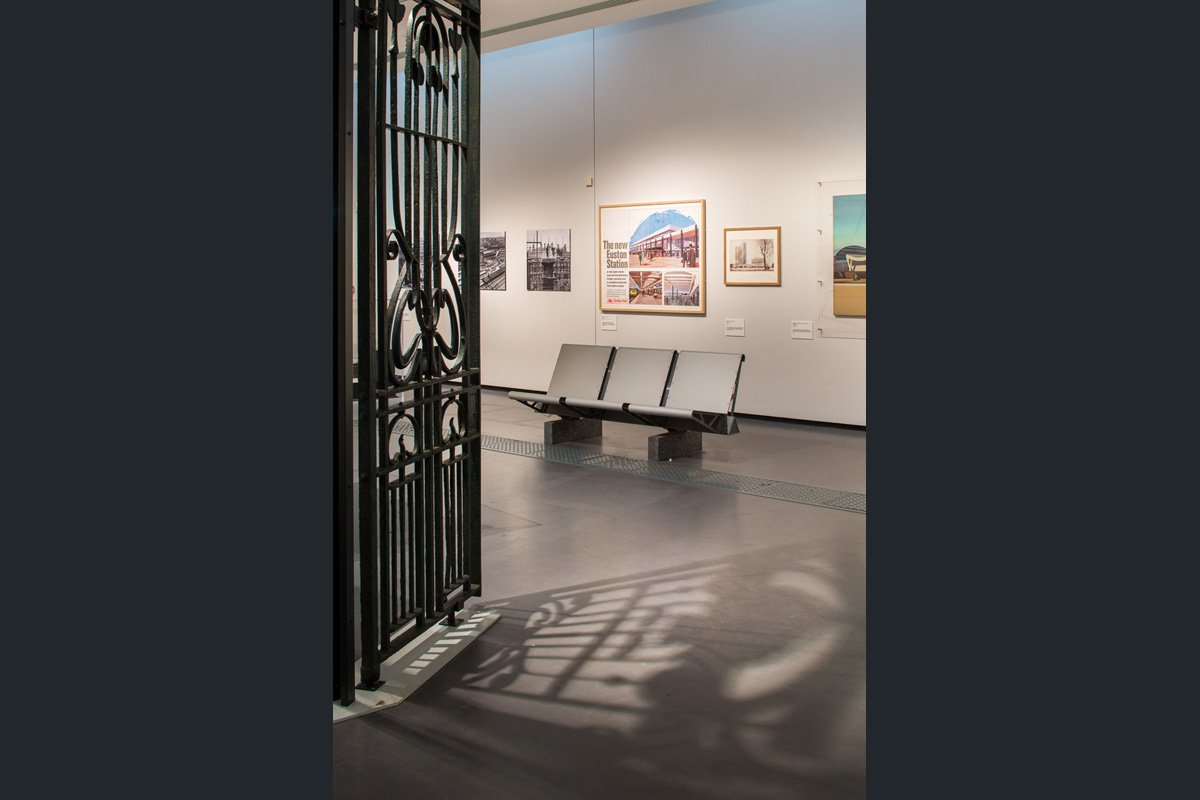 inside exhibit 'destinations stations' a piece of rail history to the left and a platform bench seat centre of frame