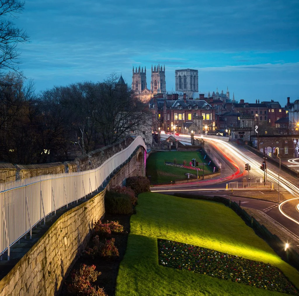 view from he city walls looking across lendall bridge towards the minster at dusk