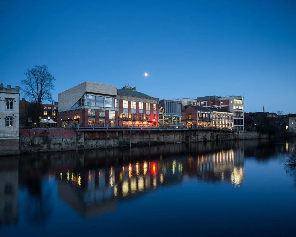 night time shot across river Ouse towards bars and restaurants 