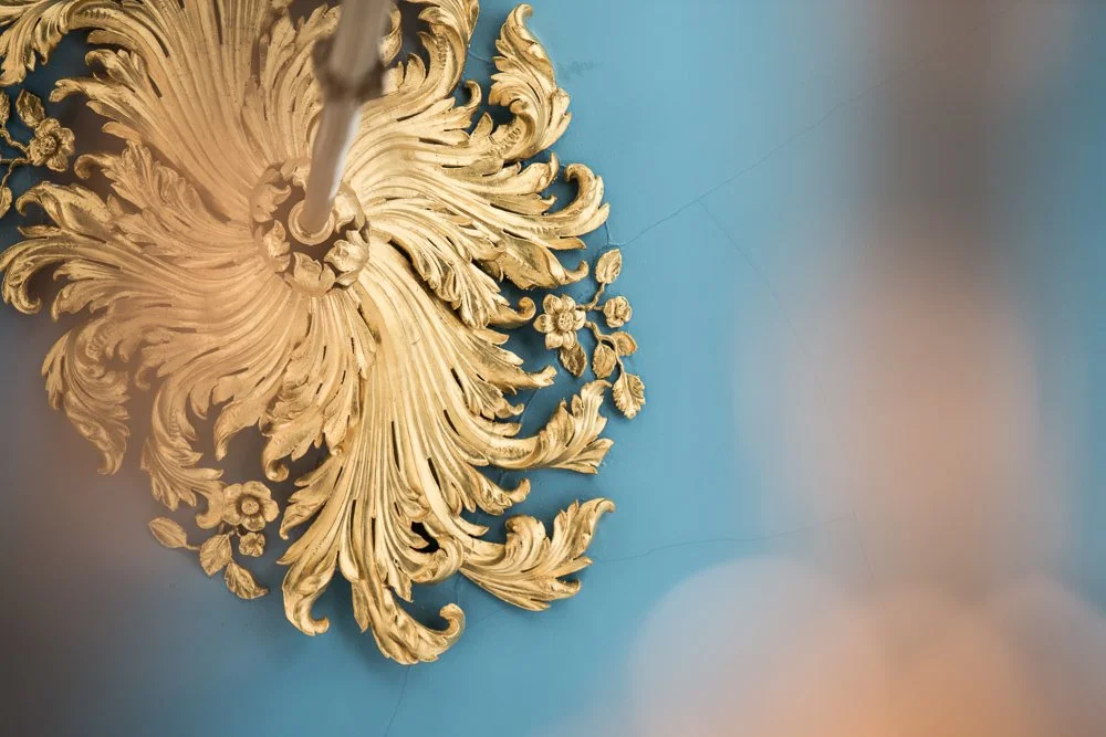 close up of intricate detail from historic restoration painted gold