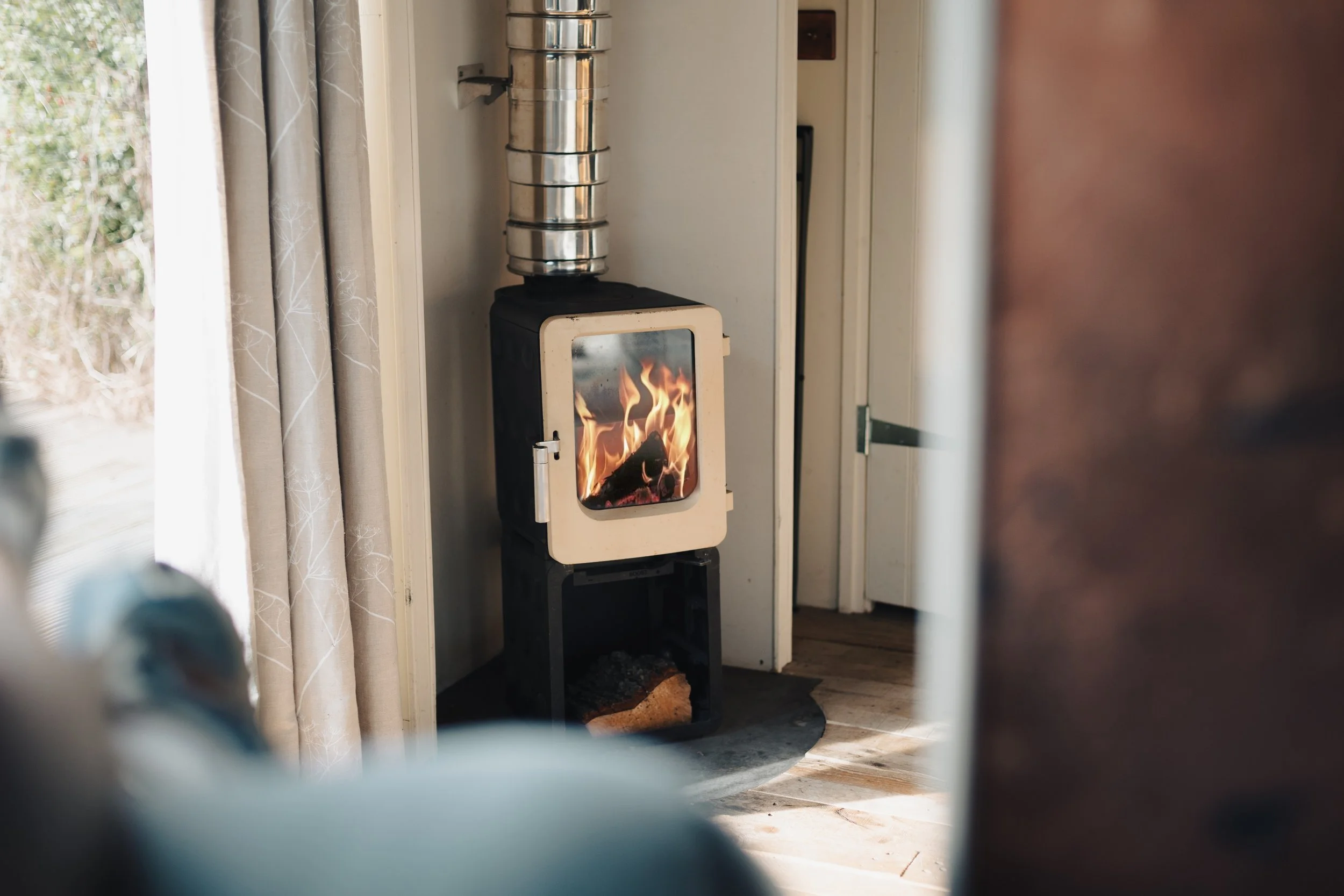 modern log burner burning, shallow depth of feild with foreground blurred 