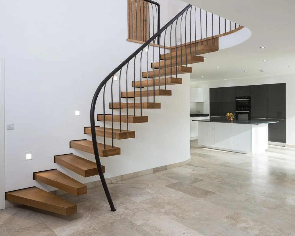 wooden staircase with black metal banister
