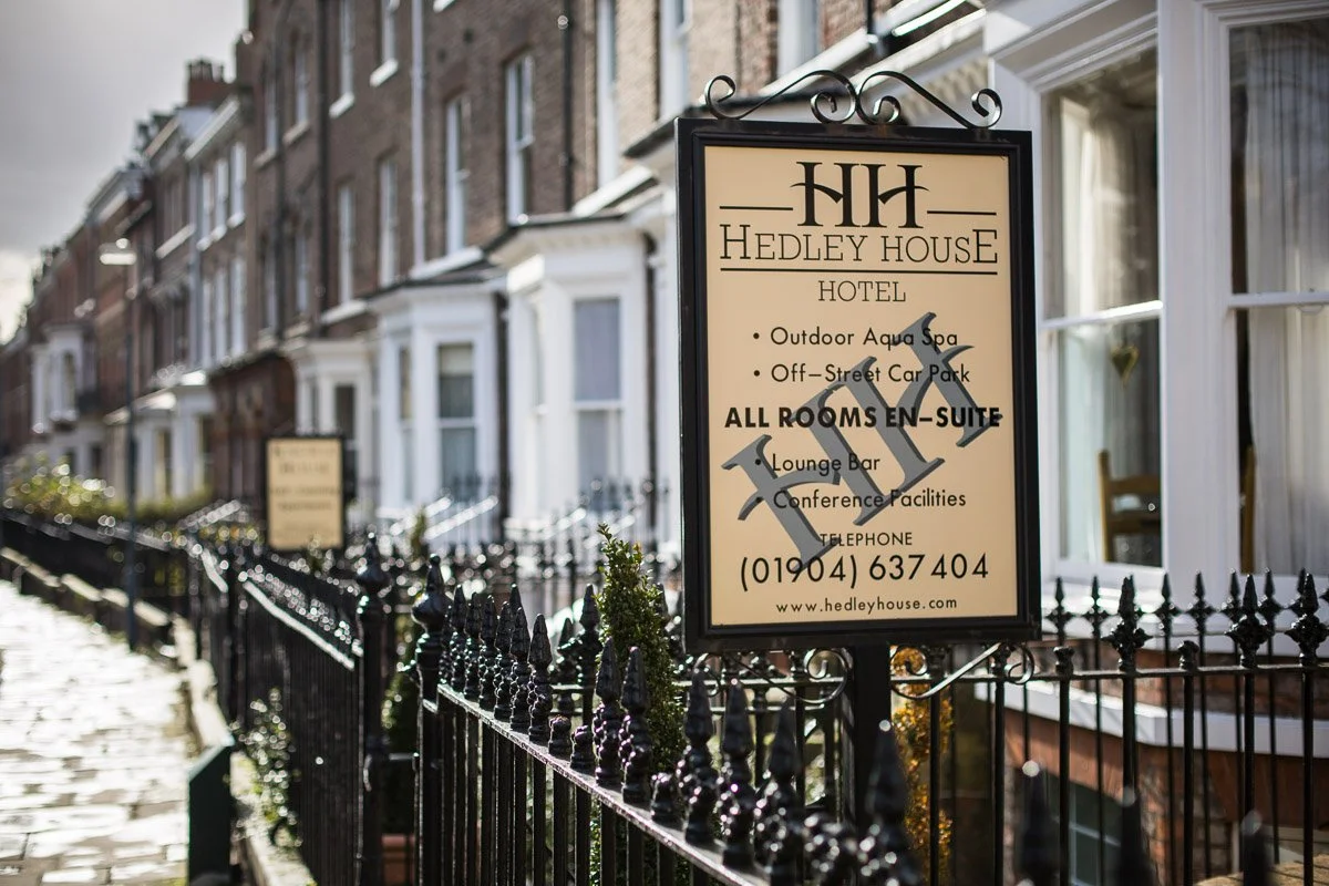 detail shot of hotel sign along fence line advertising the hotel