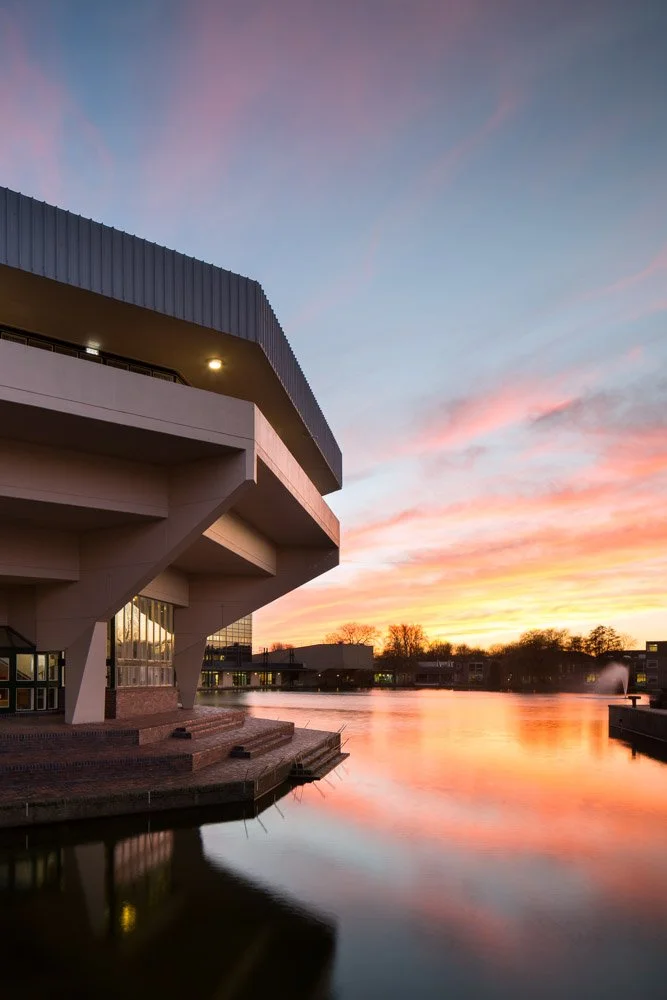 york university central hall at dusk, overlooking the waterfront 