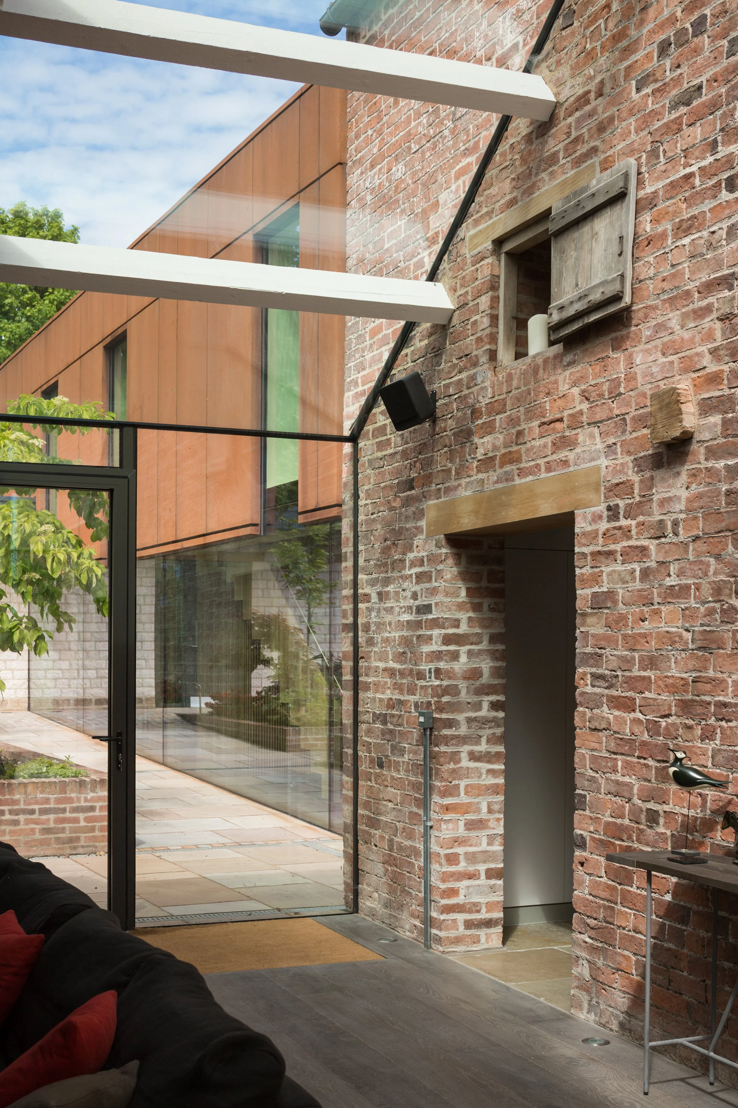 Glass link cut into brick work of red brick barn