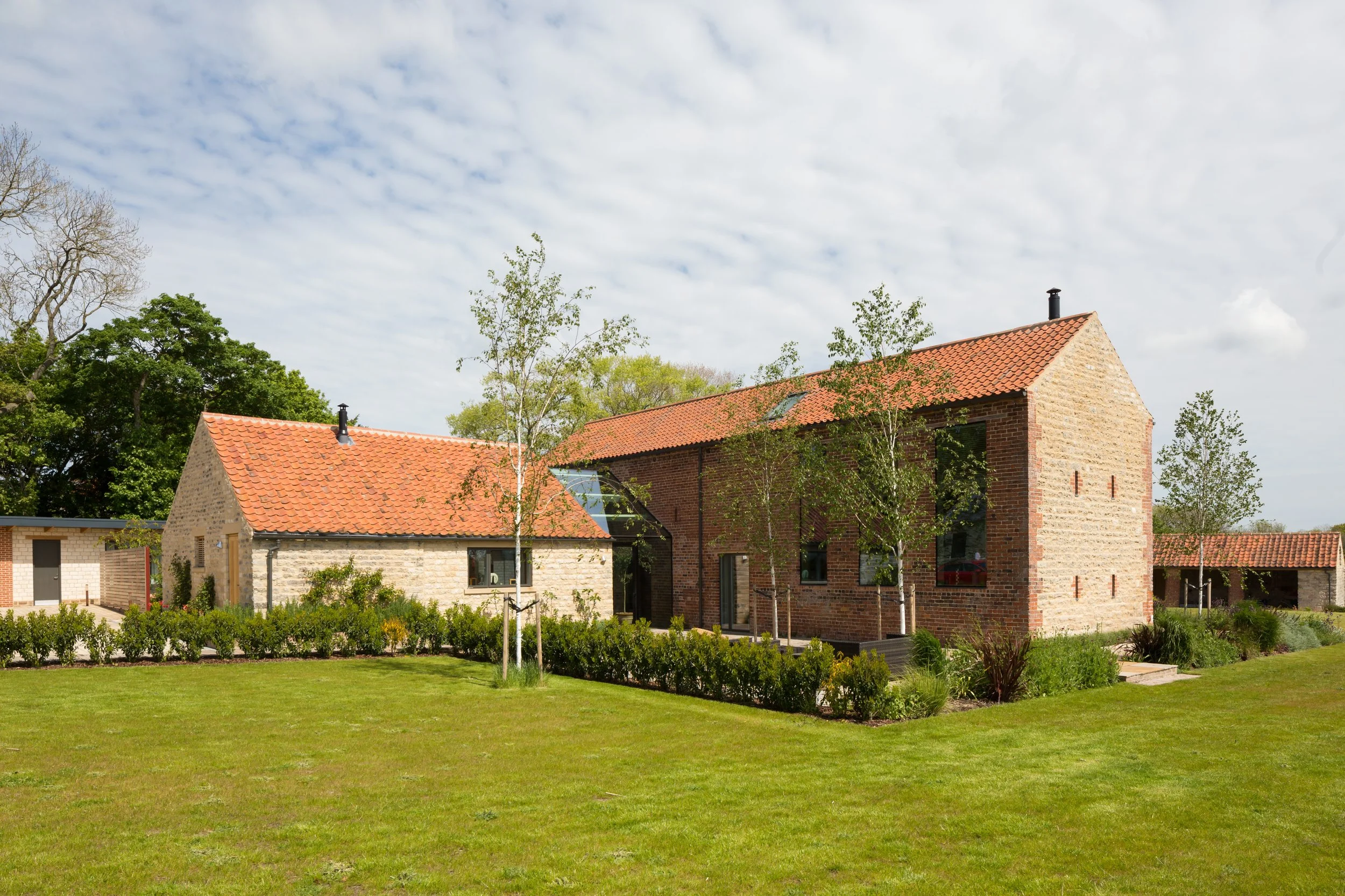 glass link between single storey building and two storey house