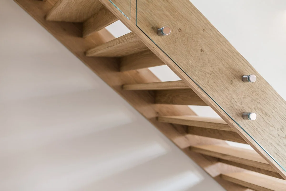 detail of wooden staircase with glass banister