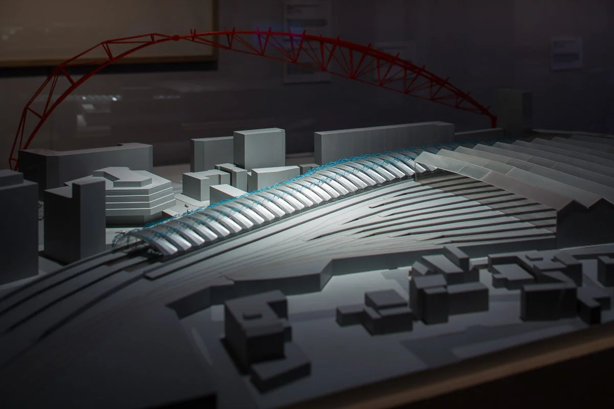 small paper model of the outside of york train station showing the rail lines, lit from above