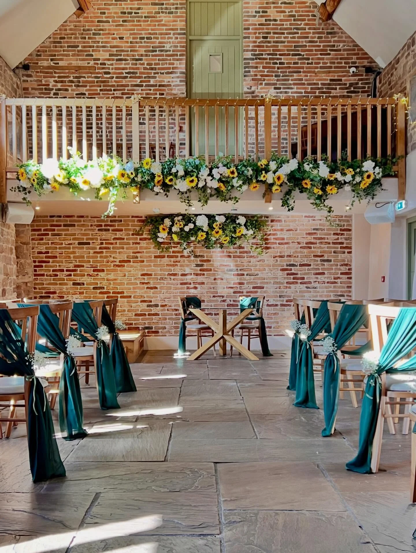 Charlie &amp; Josh. 
We supplied stunning balcony florals today at @theashesbarns, full of sunflowers, which perfectly reflected the glorious Spring sunshine.

The chairs were dressed with forest green drapes and gypsophila pew ends, chosen to comple