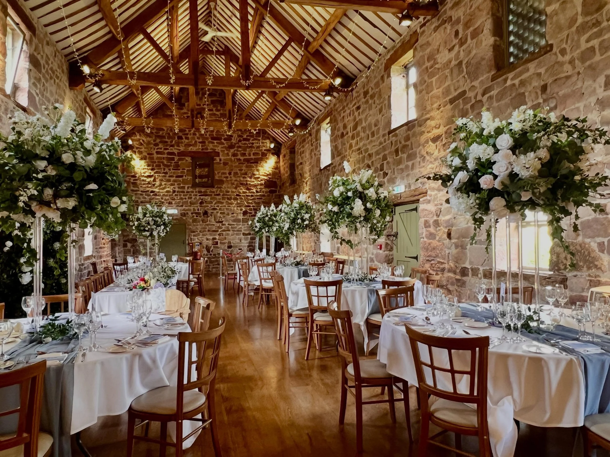 Alice &amp; Joe. The wedding breakfast was equally as perfect as the ceremony for this beautiful at @theashesbarns.
Tall florals made a statement with subtle blue highlights that brought the theme together.
#theashesbarns #barnwedding #staffordshirew