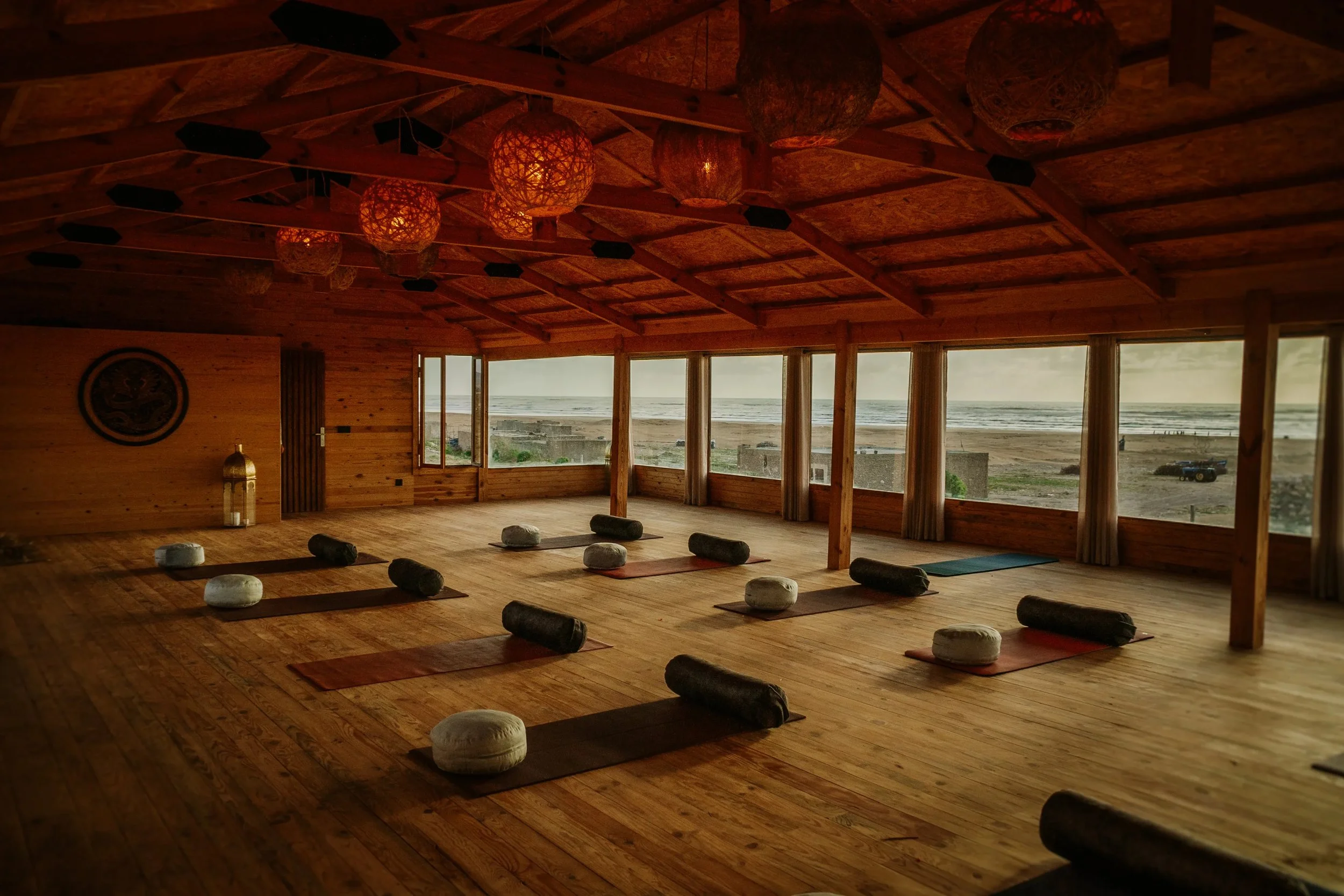 Shala de yoga avec vue panoramique sur l'océan Atlantique et tapis disposés au sol — retraite yoga et équitation Essaouira Maroc novembre 2026