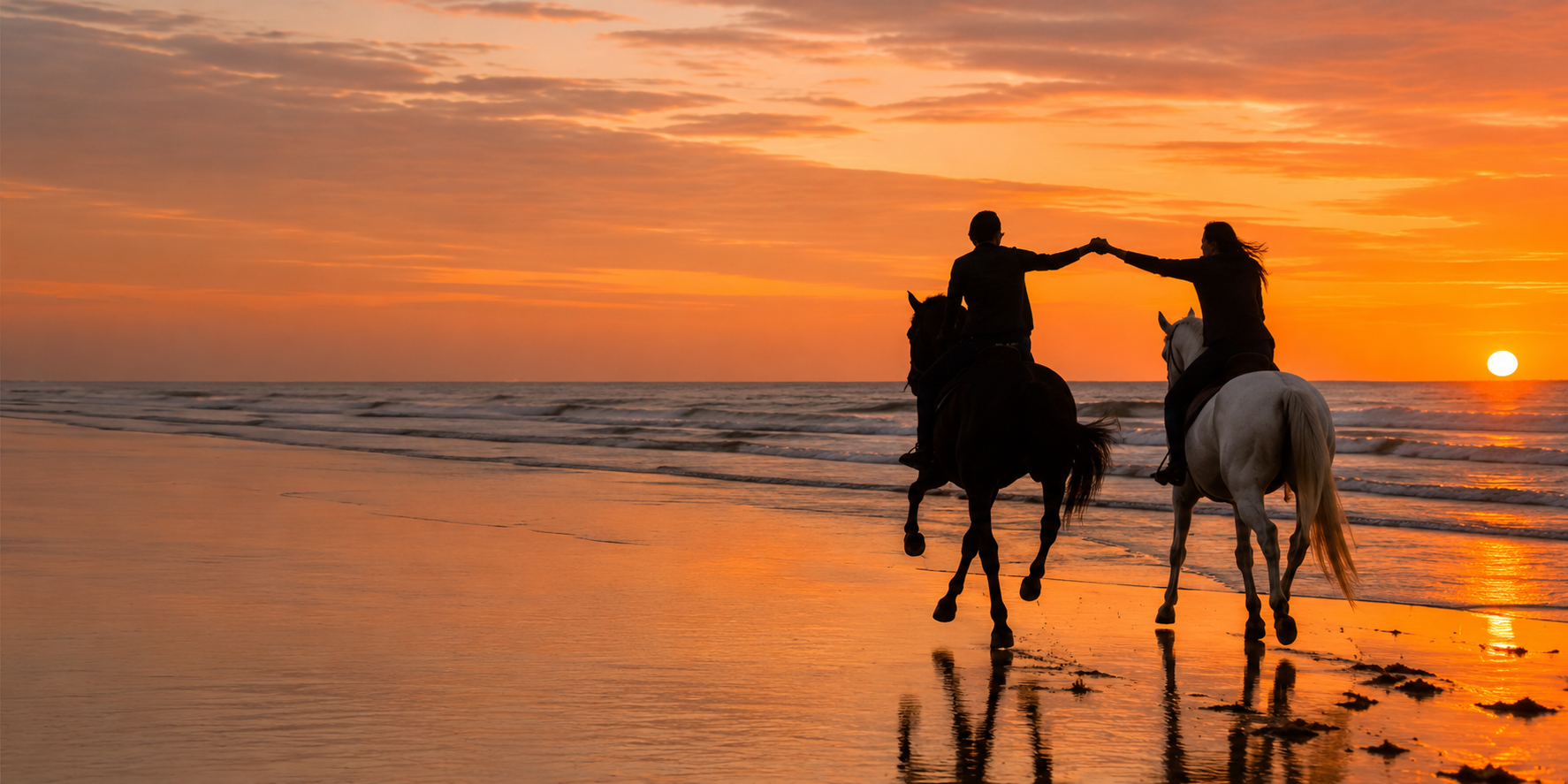 Two horse riders silhouetted on Essaouira beach at sunset — yoga and horse riding retreat Morocco November 2026 Alice Girard Yoga