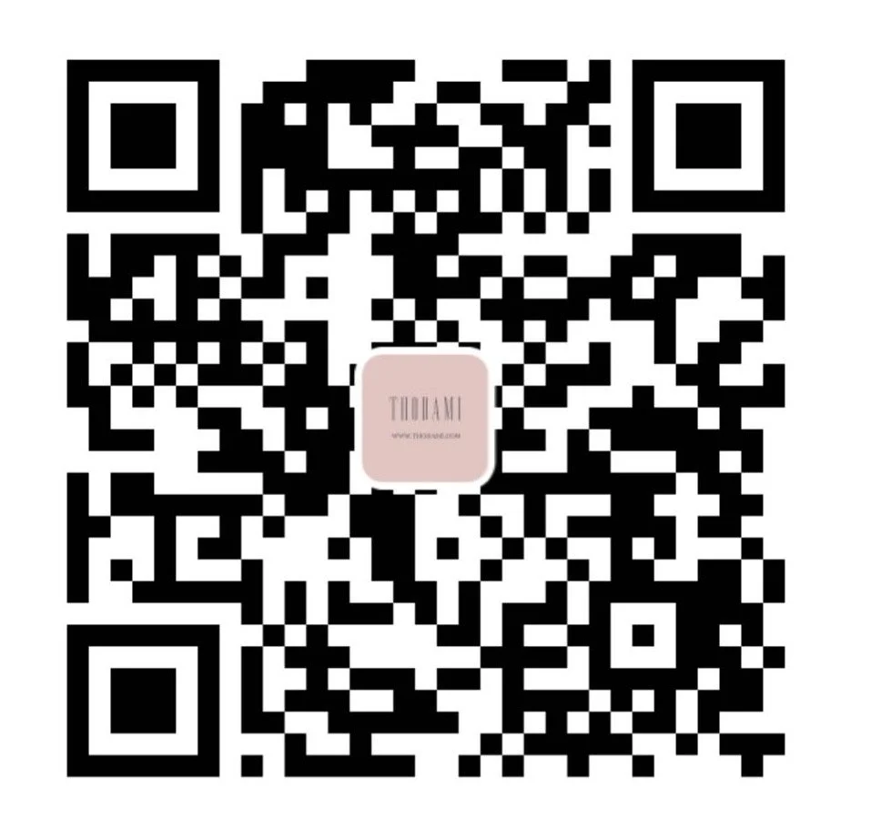 A black and white QR code with a pink square center containing the word 'TUALDI' and a website URL.