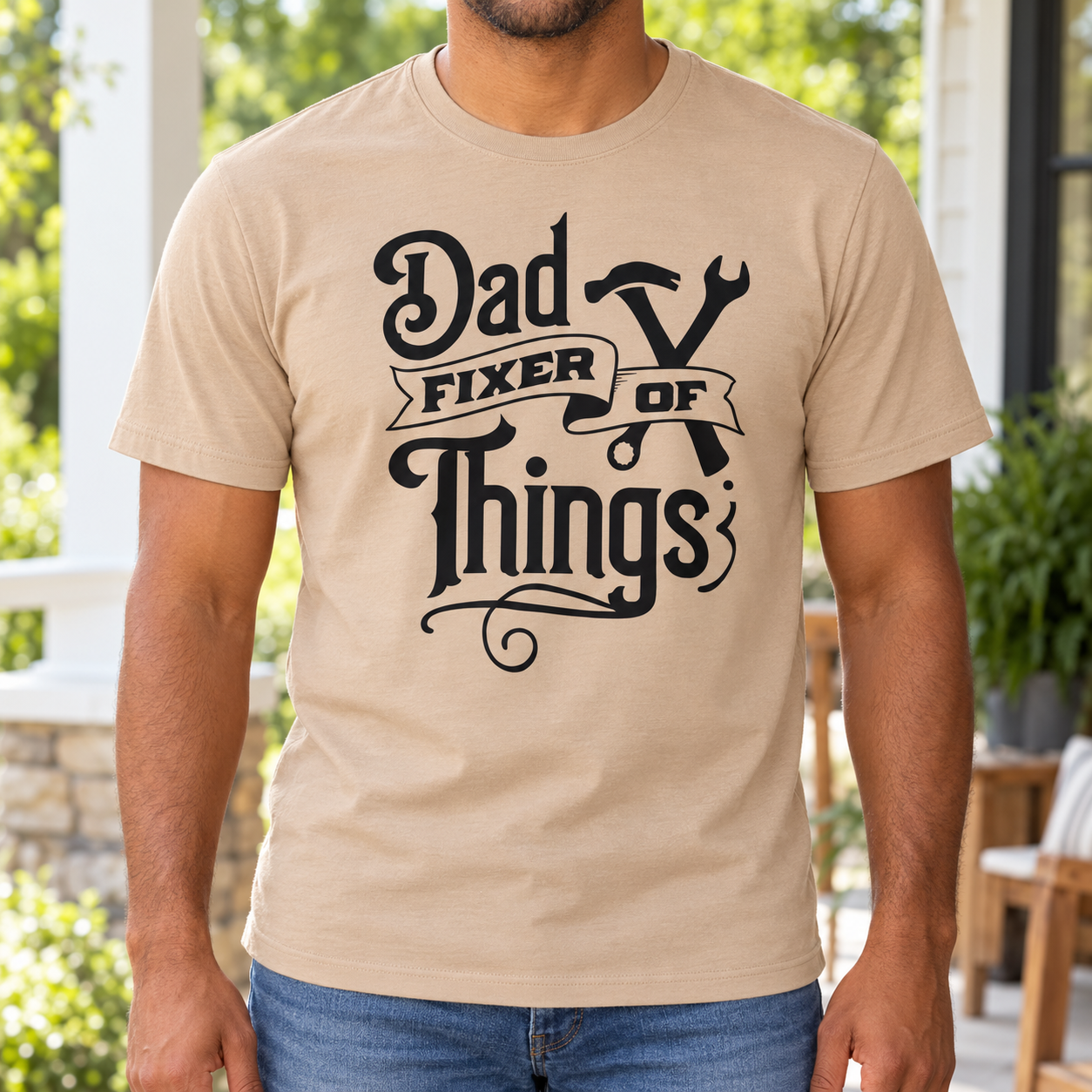 Dad Fixer of Things Graphic Tee front print on a tan crewneck tee. AI-generated lifestyle mockup.