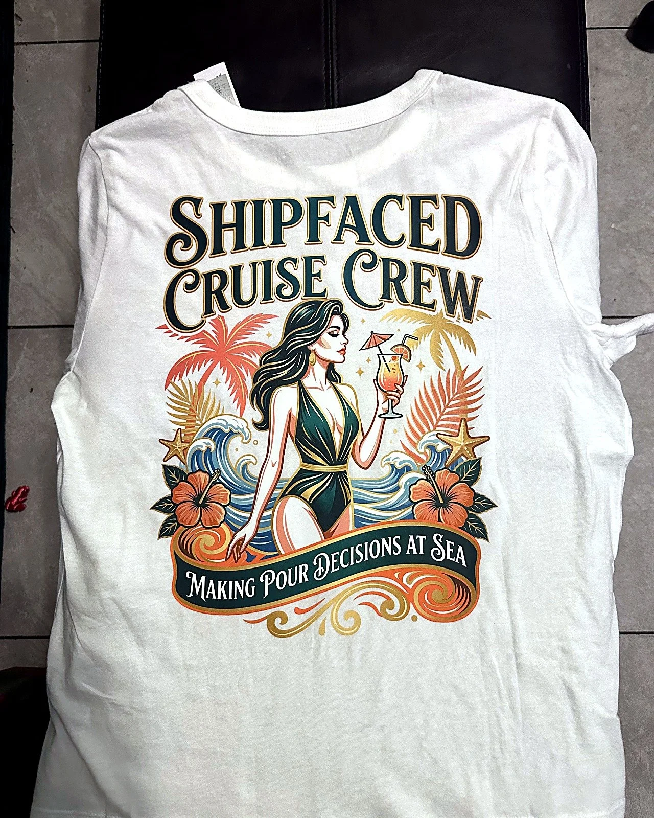 T-shirt with a graphic of a woman in a swimsuit holding a drink, surrounded by tropical flowers, palm trees, waves, and starfish, with the text 'Shipfaced Cruise Crew' and 'Making Pour Decisions at Sea'.