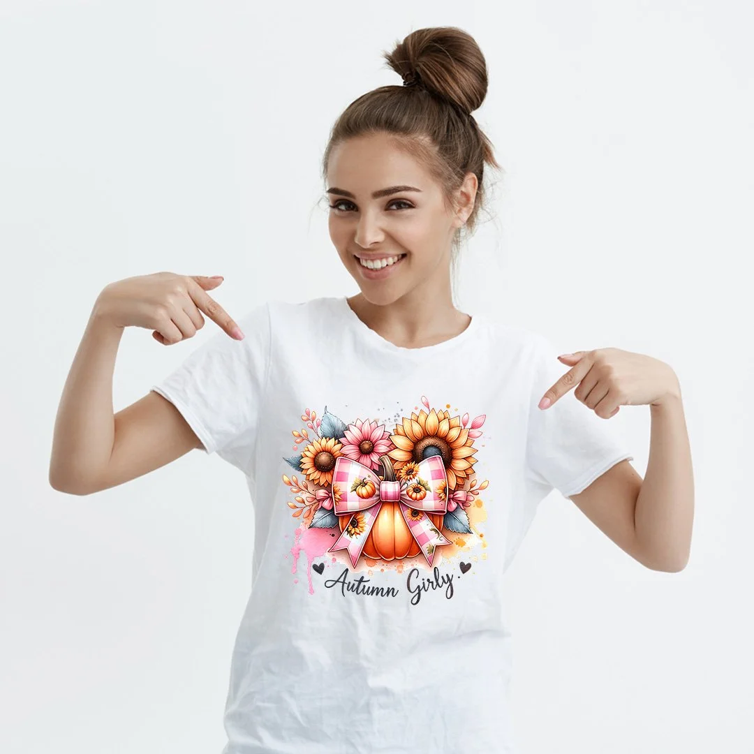 White shirt mockup with an Autumn Girly pumpkin, pink bow, and sunflower design.
