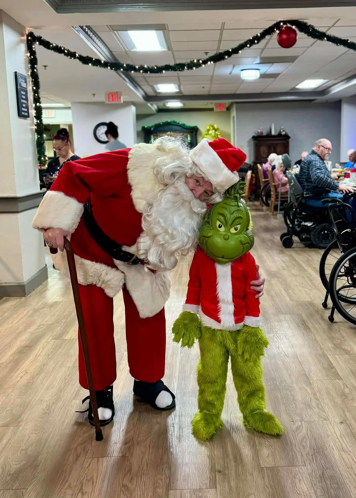 The Grinch and Santa at Ivy Knoll Senior Living Christmas Party