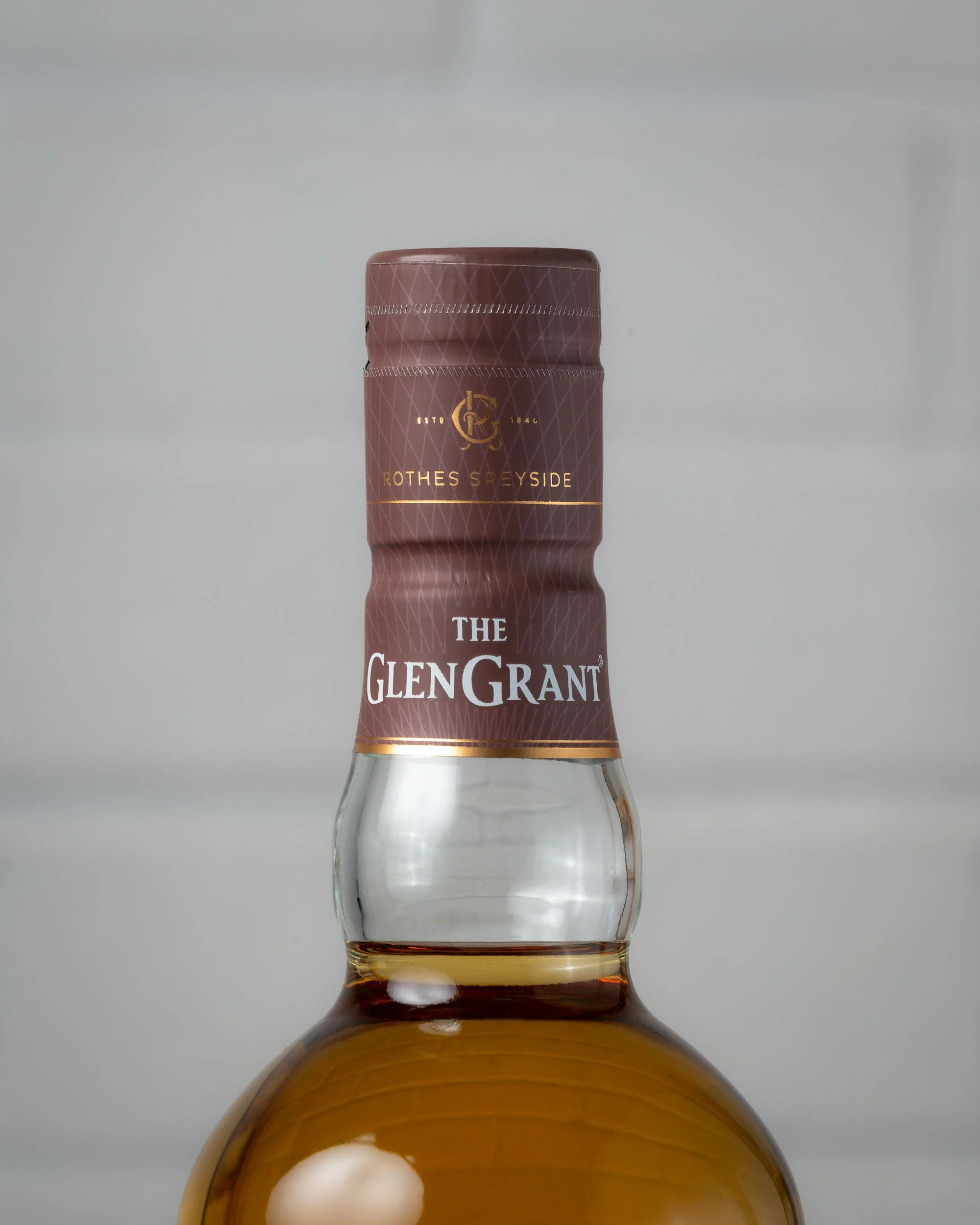 Close up of the neck of a bottle of Glen Grant 12