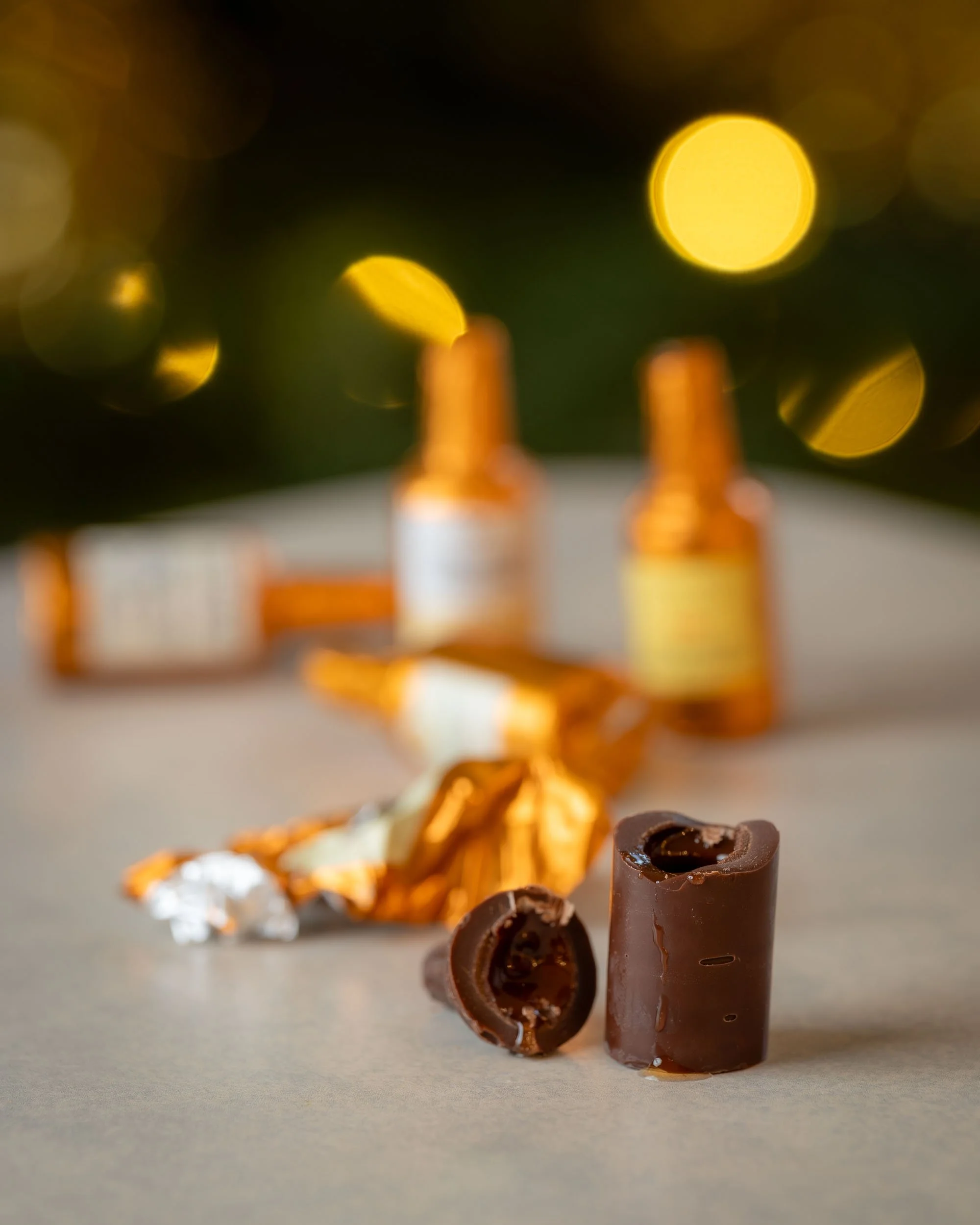 A mini chocolate liqueur bottle broken open with the whisky dripping down the outside