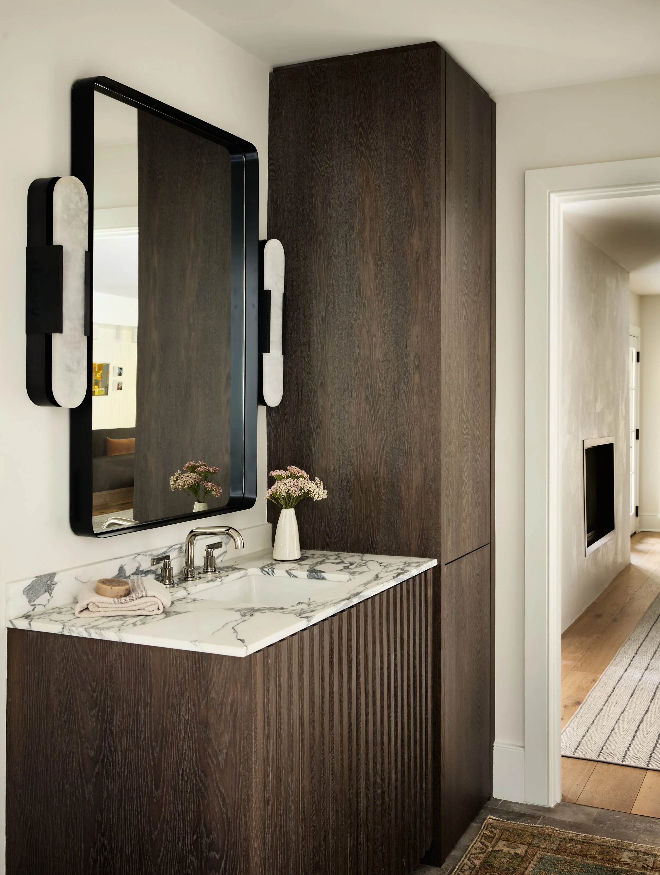 modern bathroom with sleek cabinetry and marble countertop by Studio Izlu