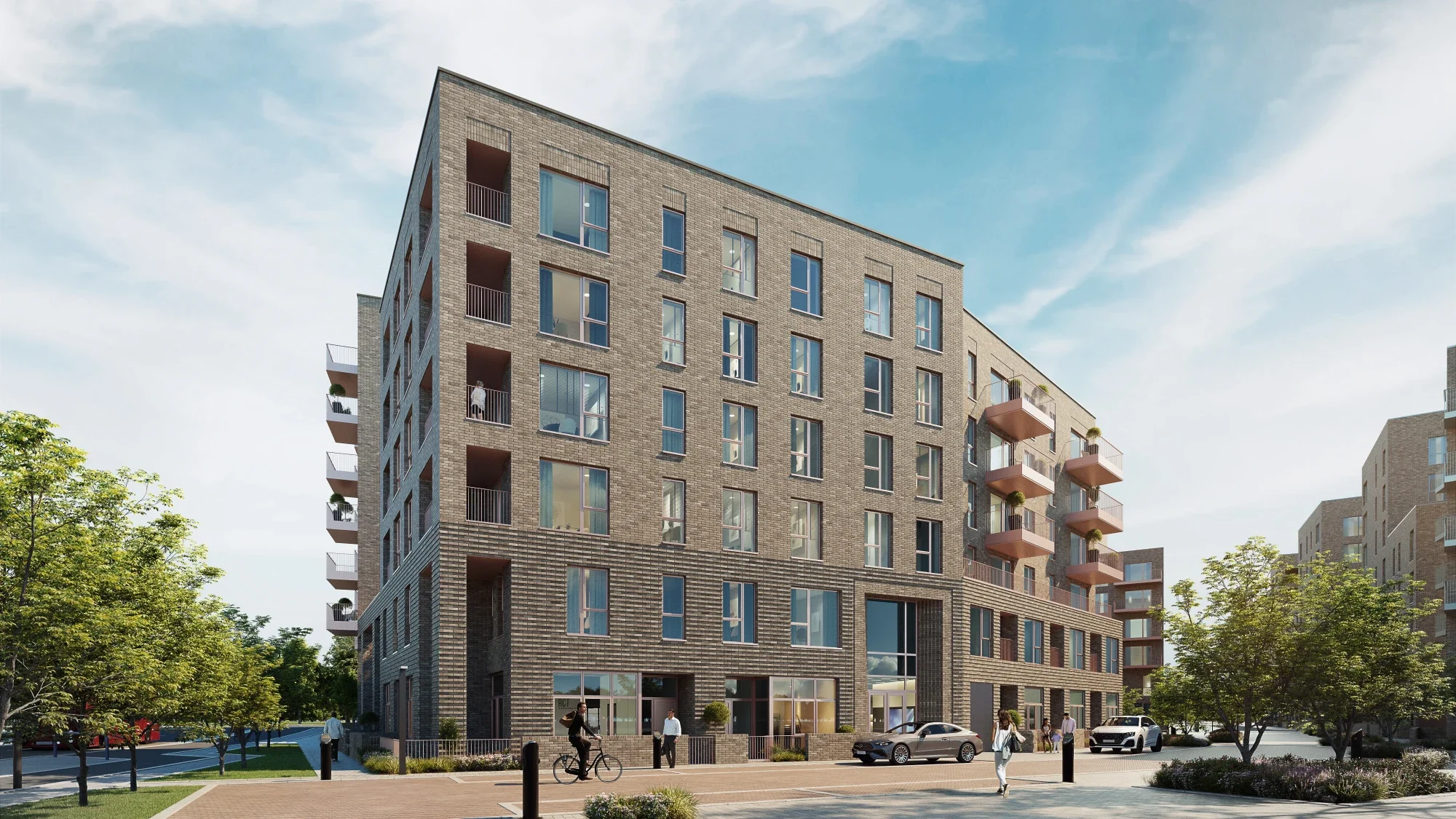 A modern multi-story residential building with brick exterior, balconies, large windows, and a ground-floor commercial space. The scene includes pedestrians, cars, a cyclist, trees, and a clear blue sky.