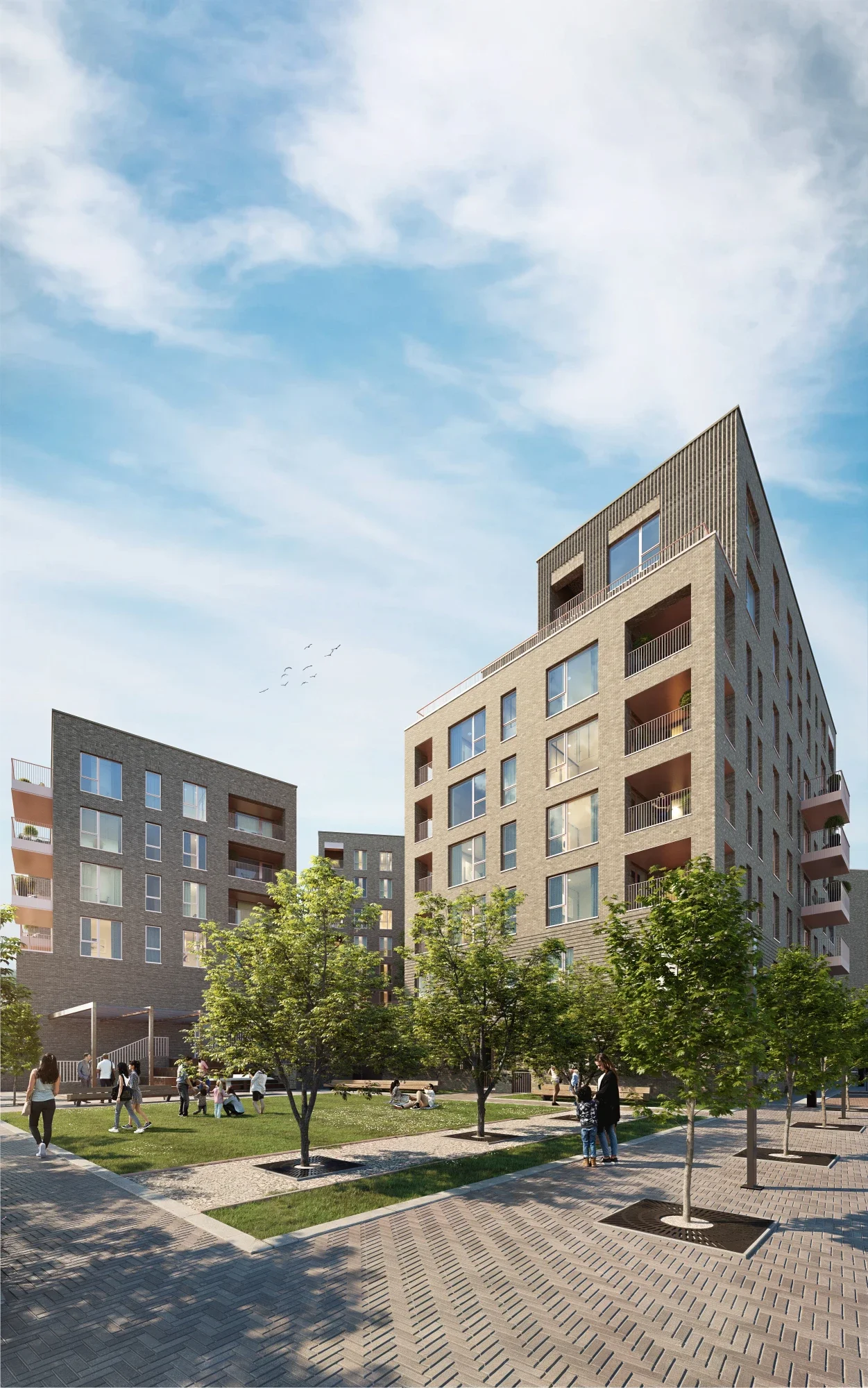 A modern residential apartment complex with multiple stories, balconies, and large windows. There is a communal area with trees, paved walkways, and people socializing and relaxing on benches under a partly cloudy sky.