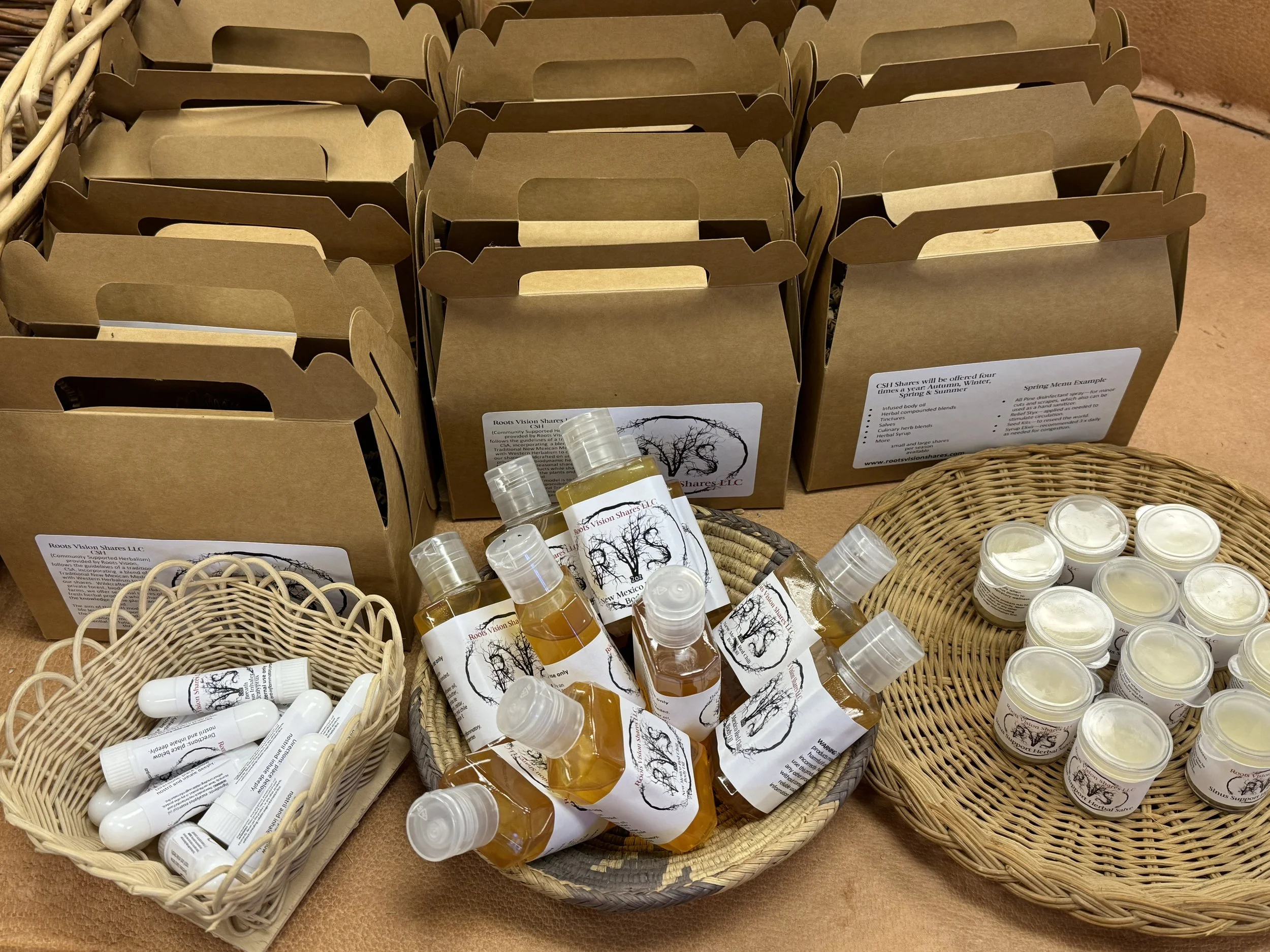 Community sponsored herbalism share boxes containing various seasonal herbal products