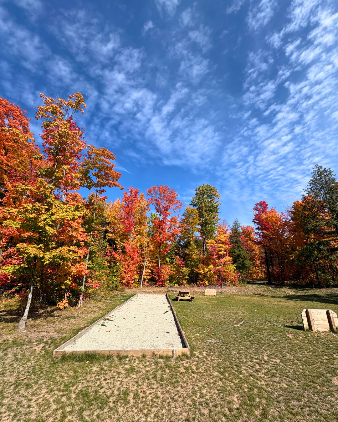 Picnic area surrounded by vibrant fall colors at Raging River Resort in Marquette, Michigan’s Upper Peninsula.