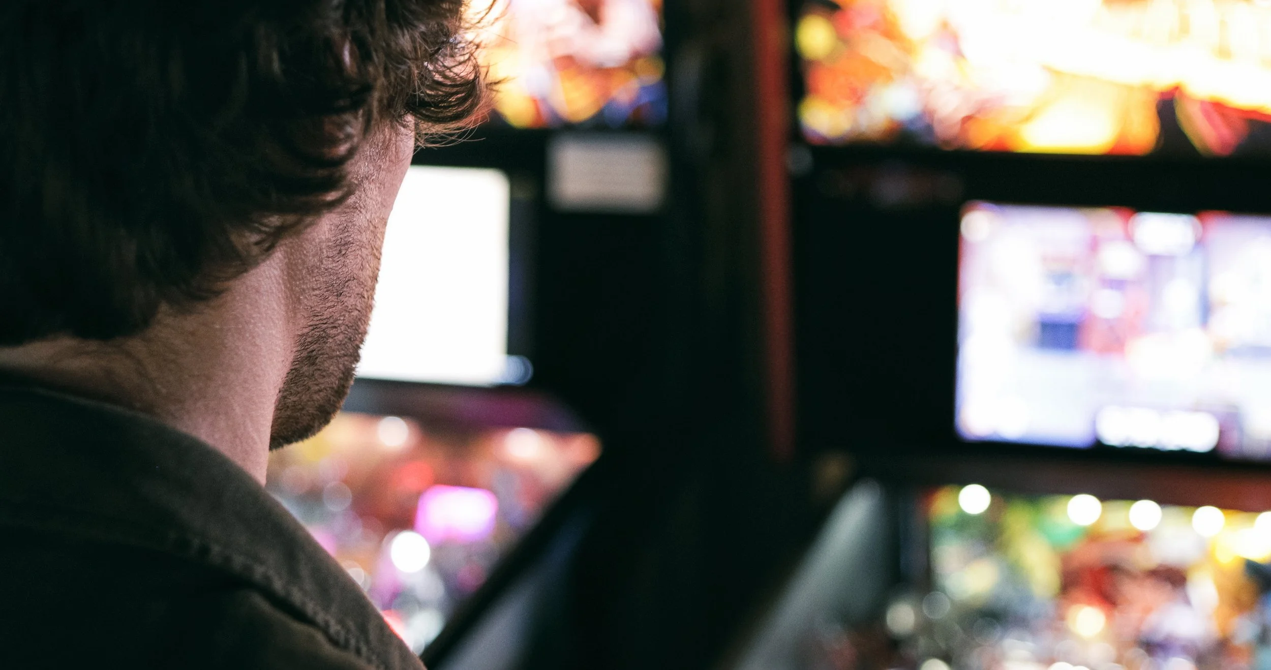 Guy playing an arcade game