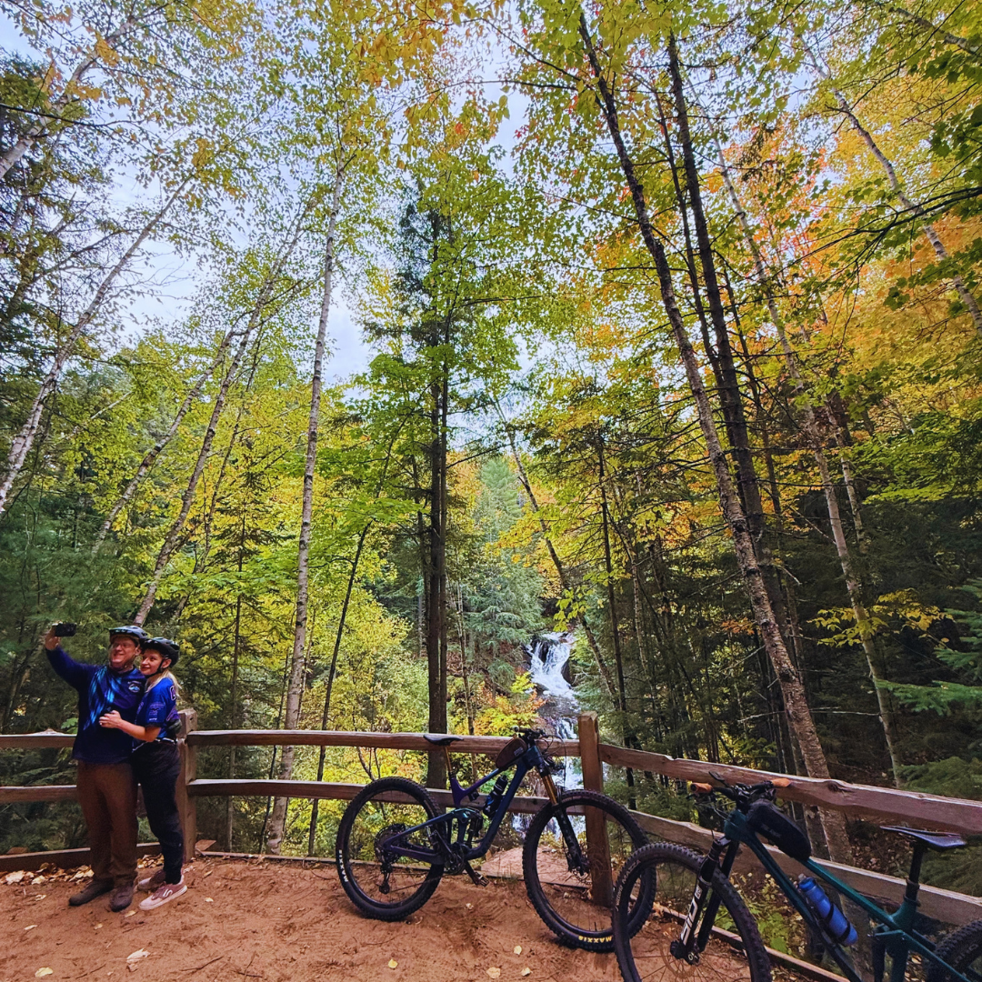 Cyclists enjoying scenic mountain biking trails surrounded by fall foliage at Raging River Resort in Marquette, Michigan’s Upper Peninsula.