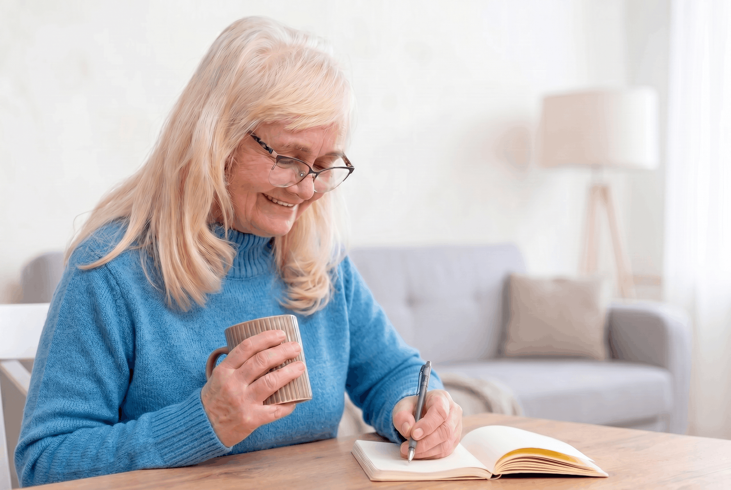 Elderly White Lady Writing in Journal Home Setting