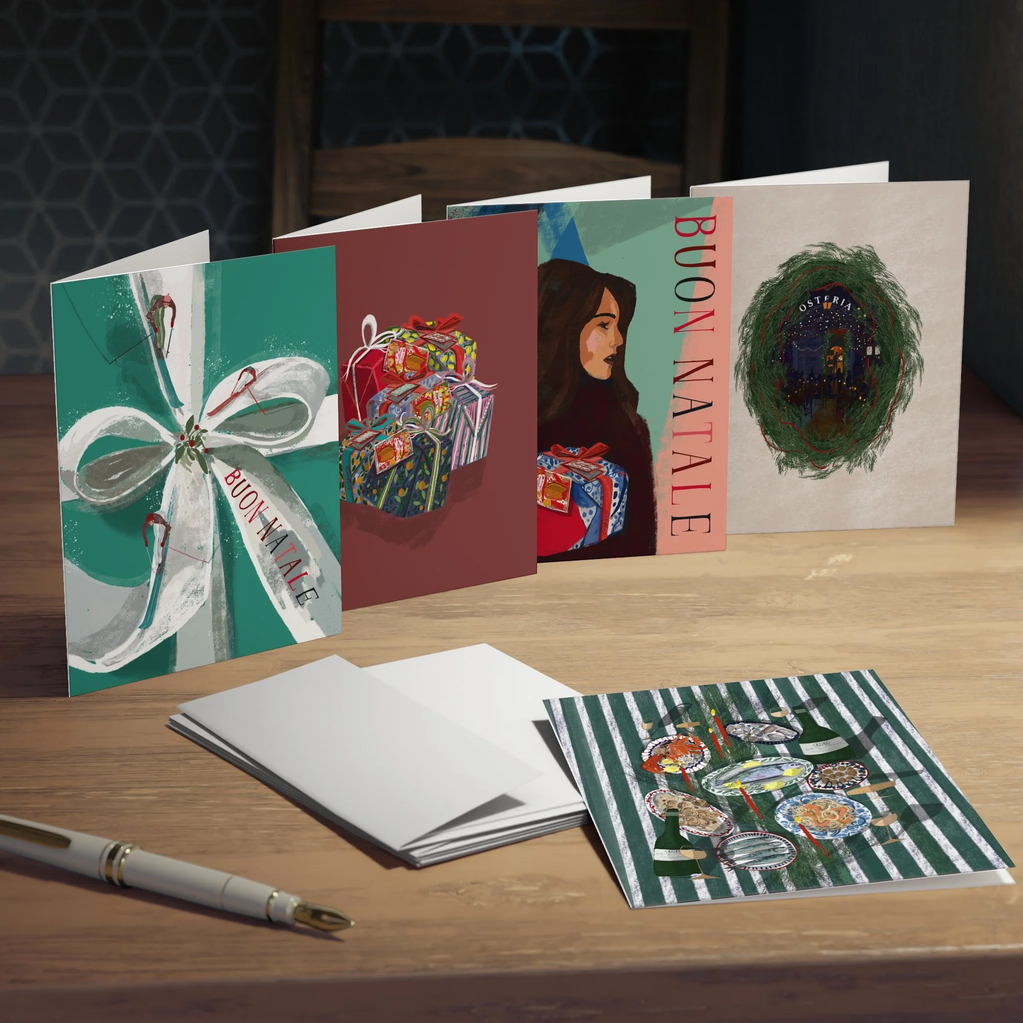 Four greeting cards with Christmas-themed illustrations and text standing upright on a wooden table, with a pen, blank white cards, and a printout of a holiday dinner on the table.