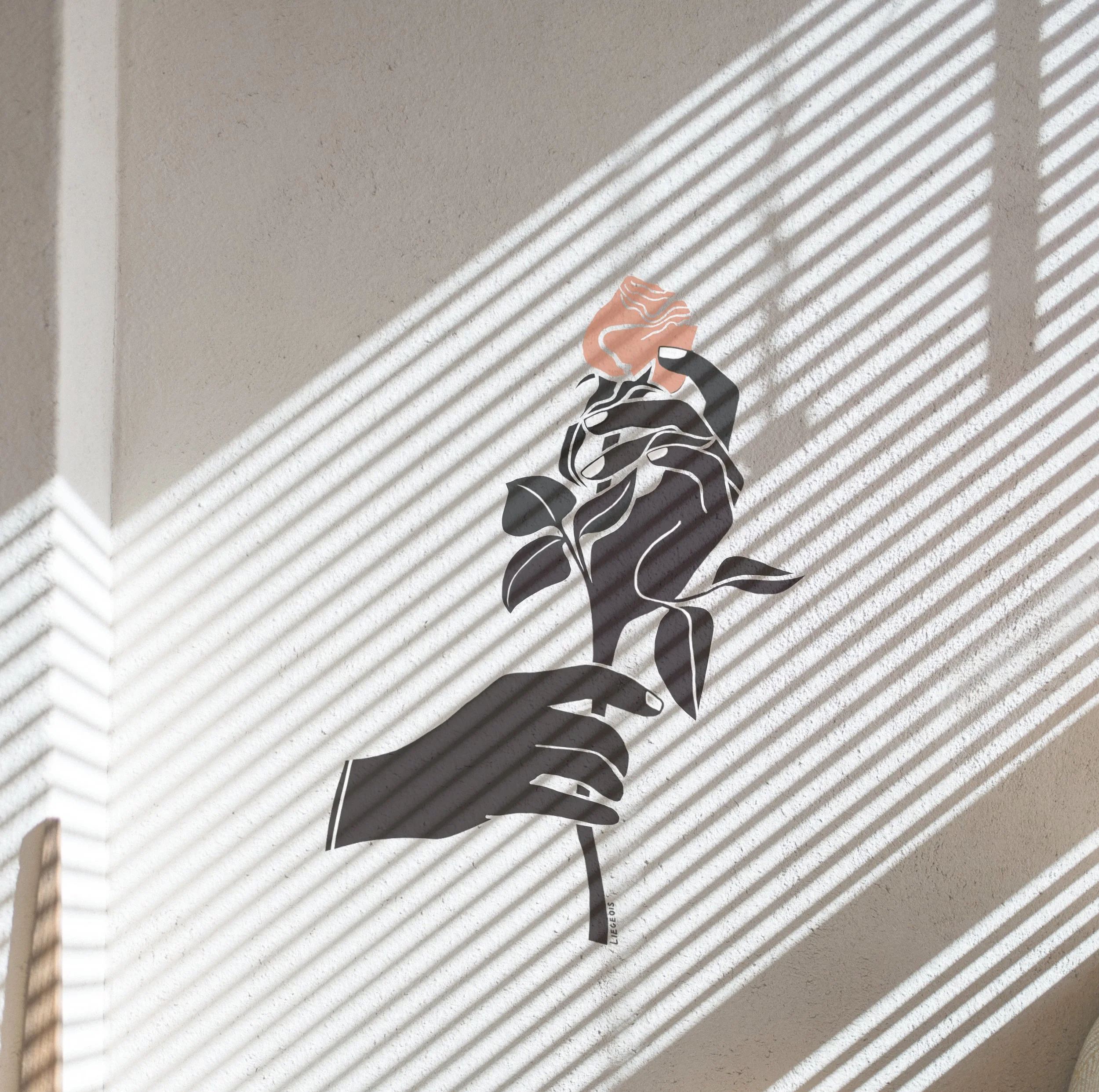 Black and white wall decal of a hand holding a plant with a pink flower, cast in shadows from window blinds.