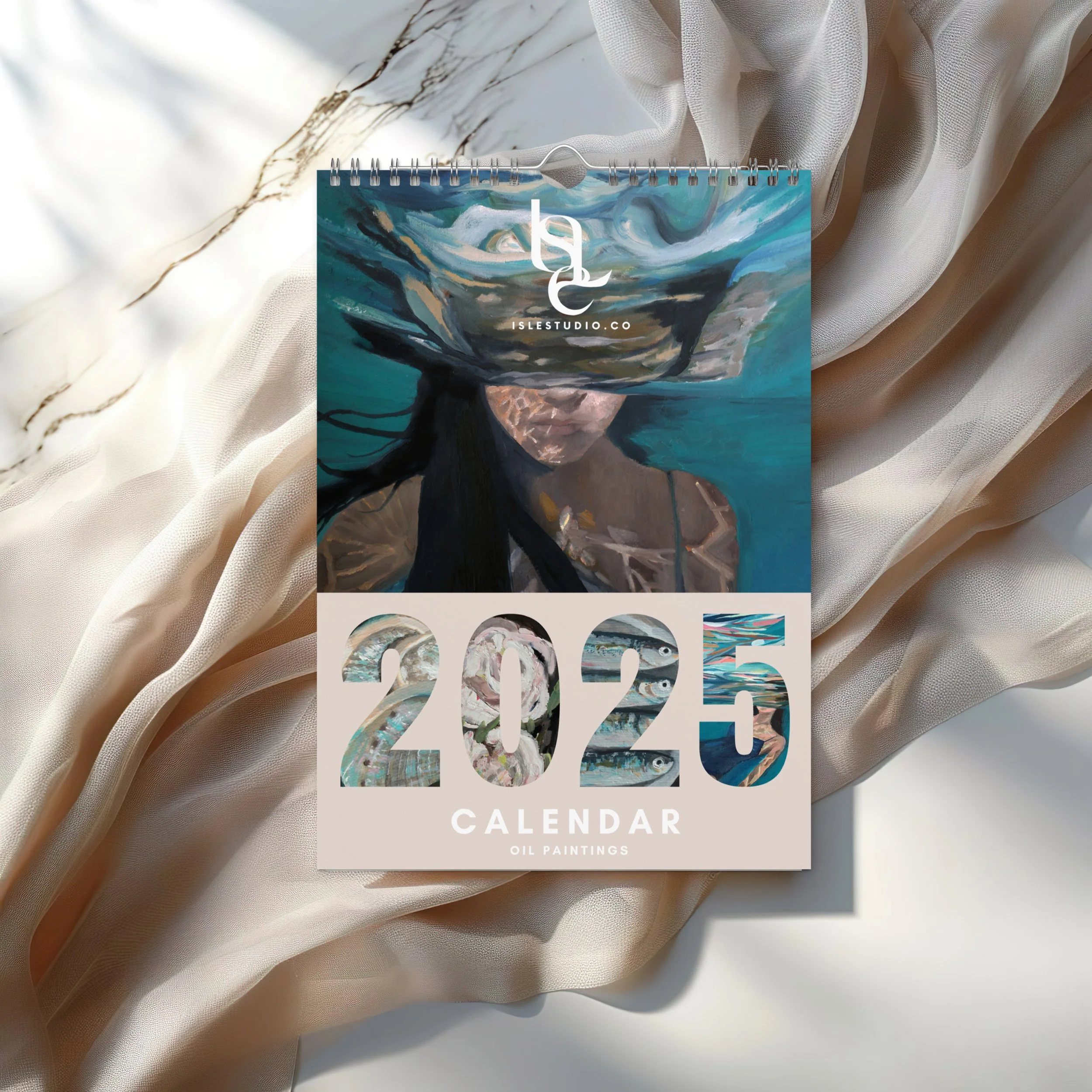 2025 calendar with oil paintings cover image of a woman underwater with her face partially submerged, surrounded by flowing hair and water, on a soft fabric background.