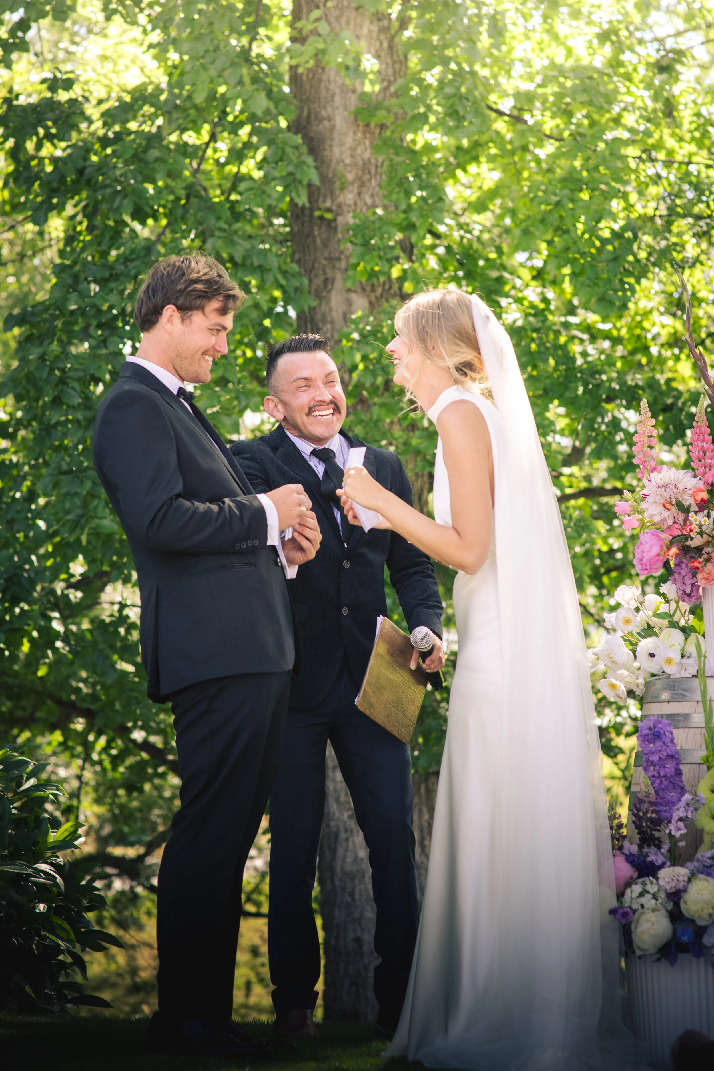 Jason Medina as a celebrant for a wedding laughing with the newly weds