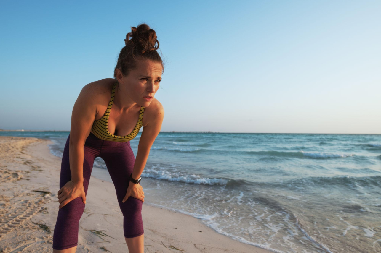 athlete resting and controlling breathing after exercise