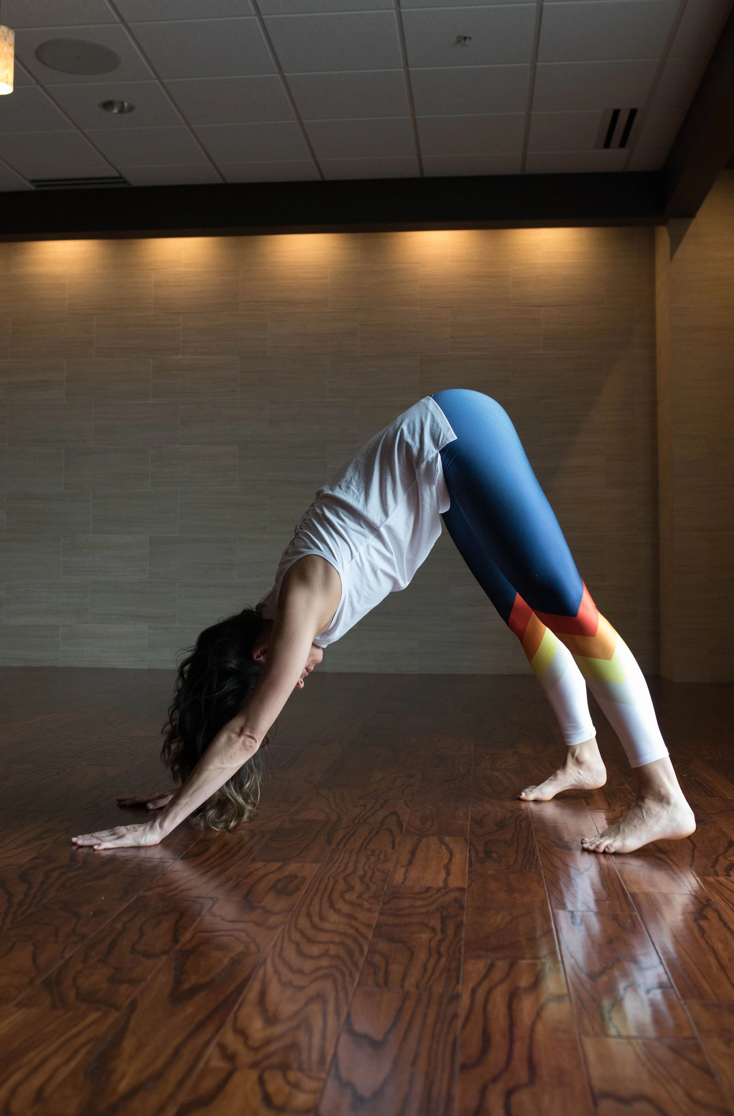 Demonstrating a downward dog stretch often used to improve flexibility, though improper stretching can reinforce poor posture patterns