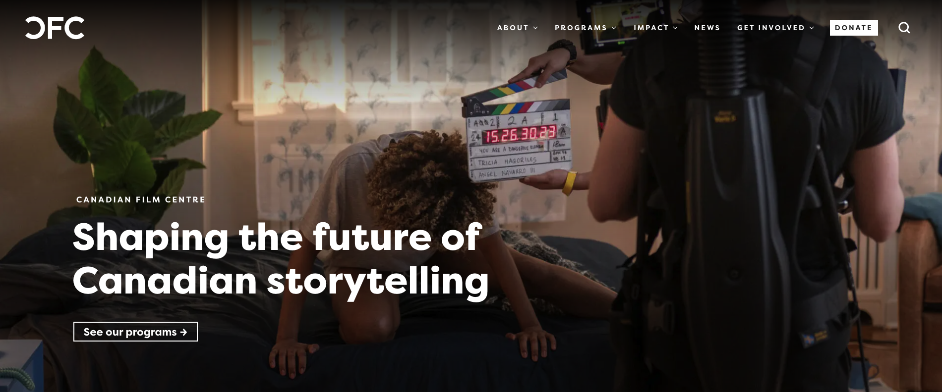 An image of a woman on a bed with a clapboard and a camera crew in front filming a movie and the words "Shaping the future of Canadian storytelling"