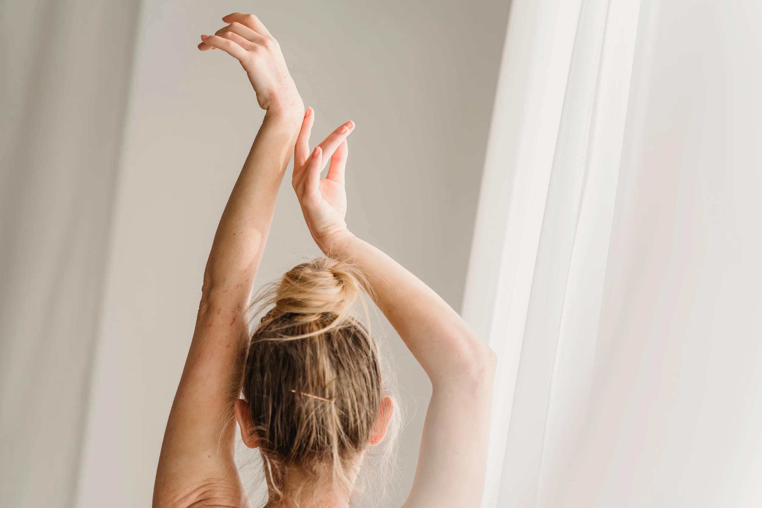 Relaxed arms above their head doing gentle movement