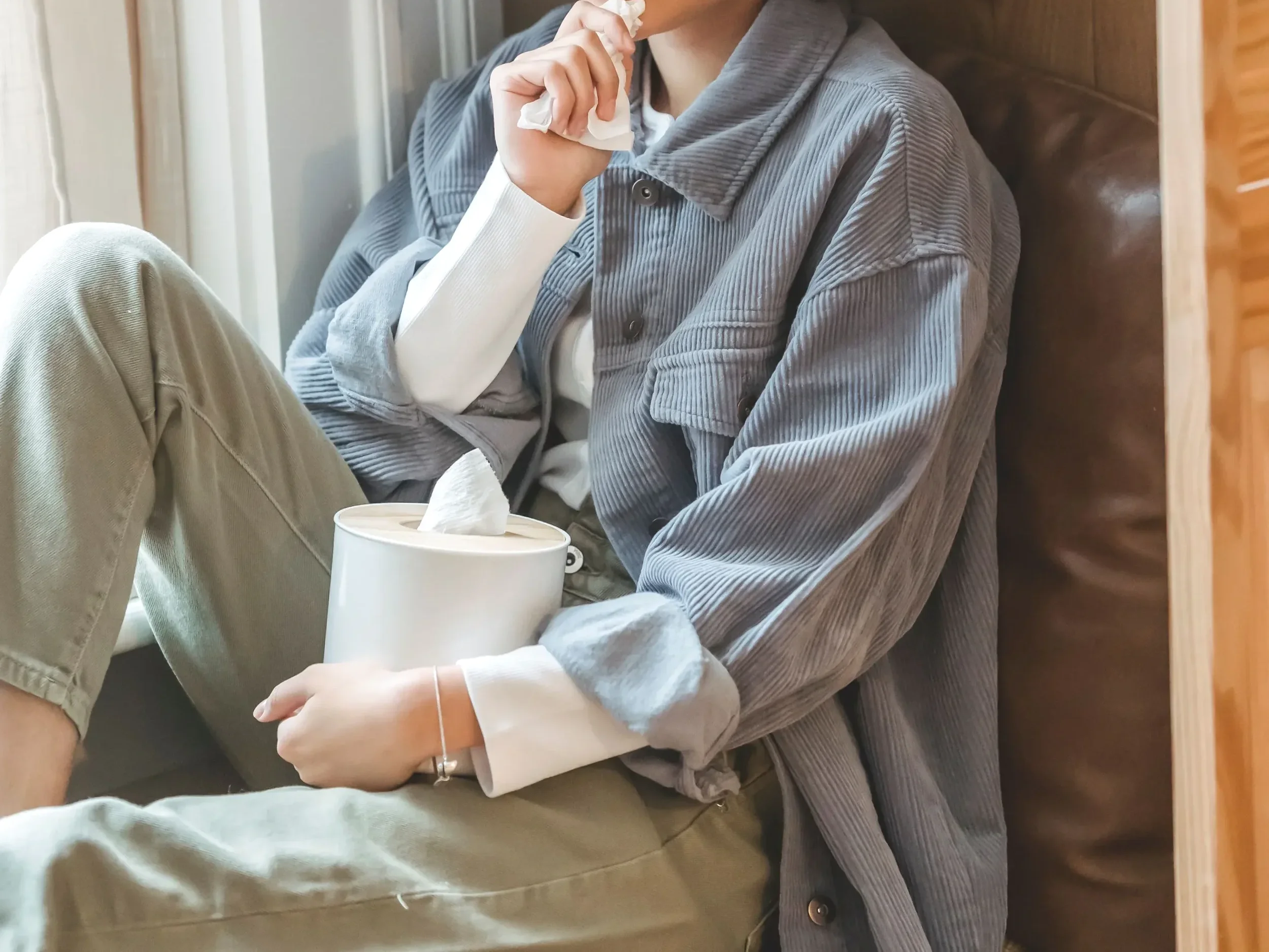 Women sitting with her box of tissues feeling her emotions.