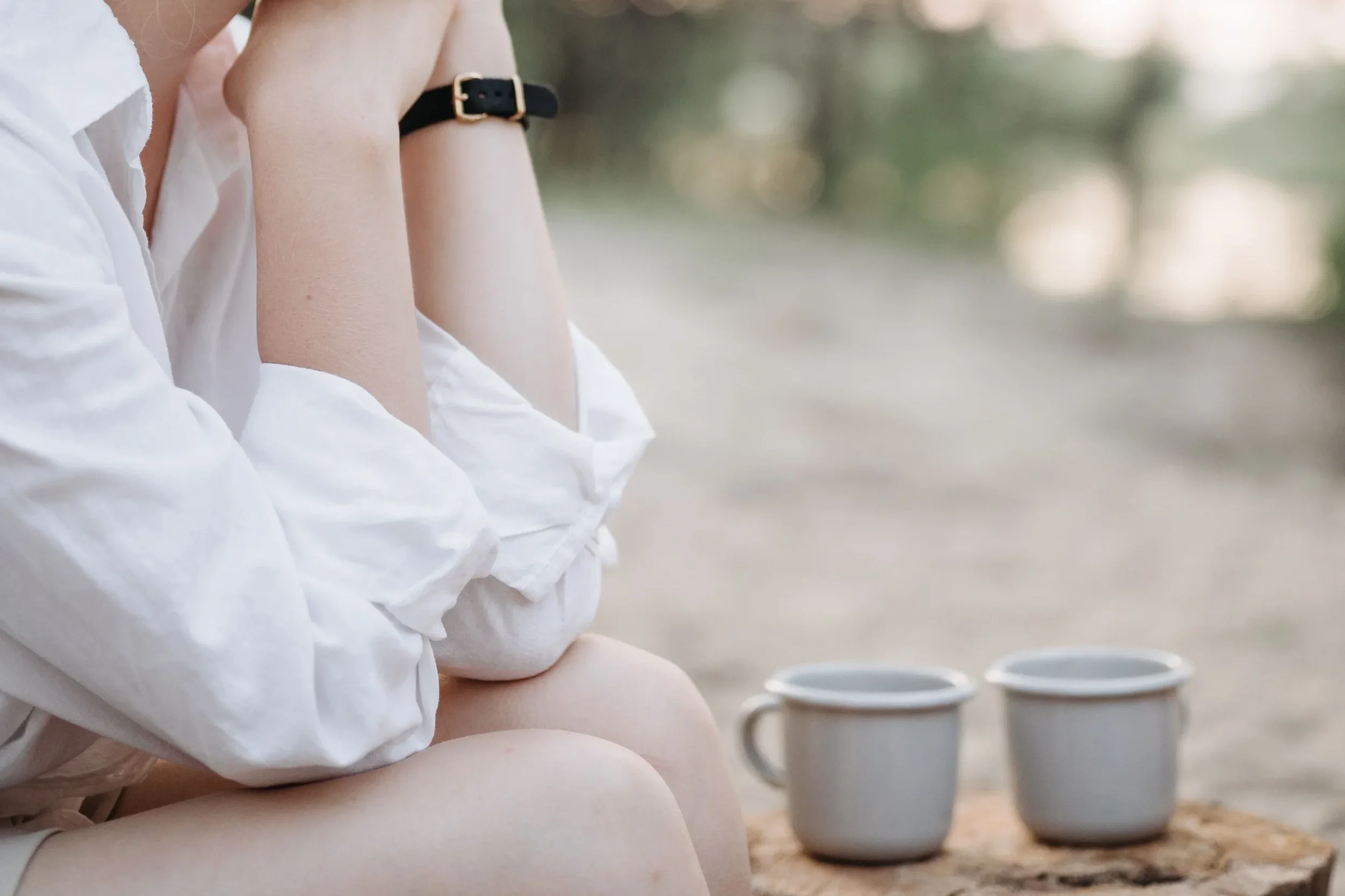 Women sitting outside having a coffee in deep thought.