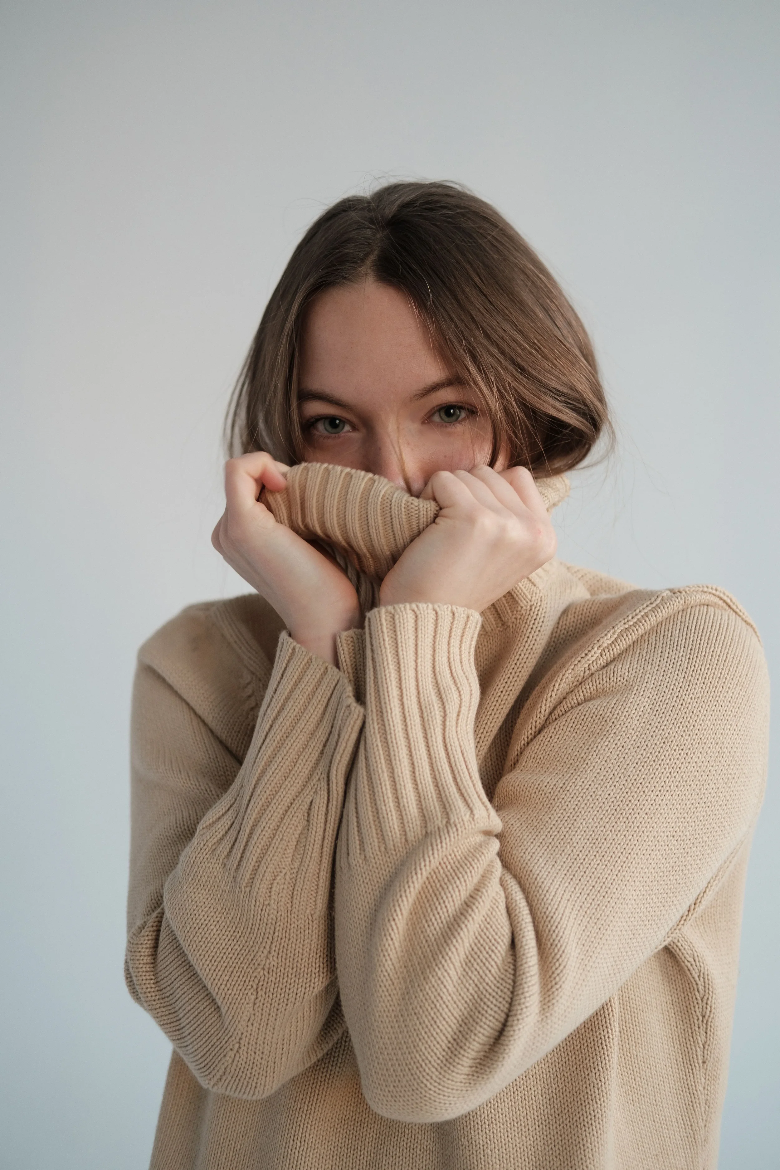 Women wearing a fuzzy sweater feeling confident.