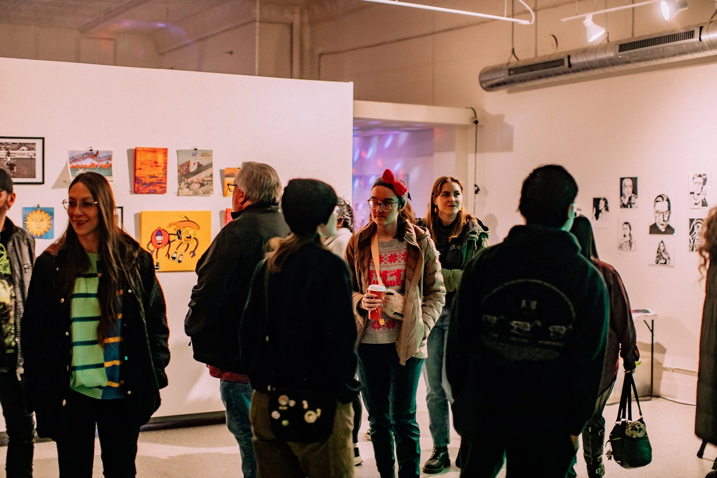 Two mannequin hands and a reflective sphere on a shelf, with a mosaic mask in dim lighting.